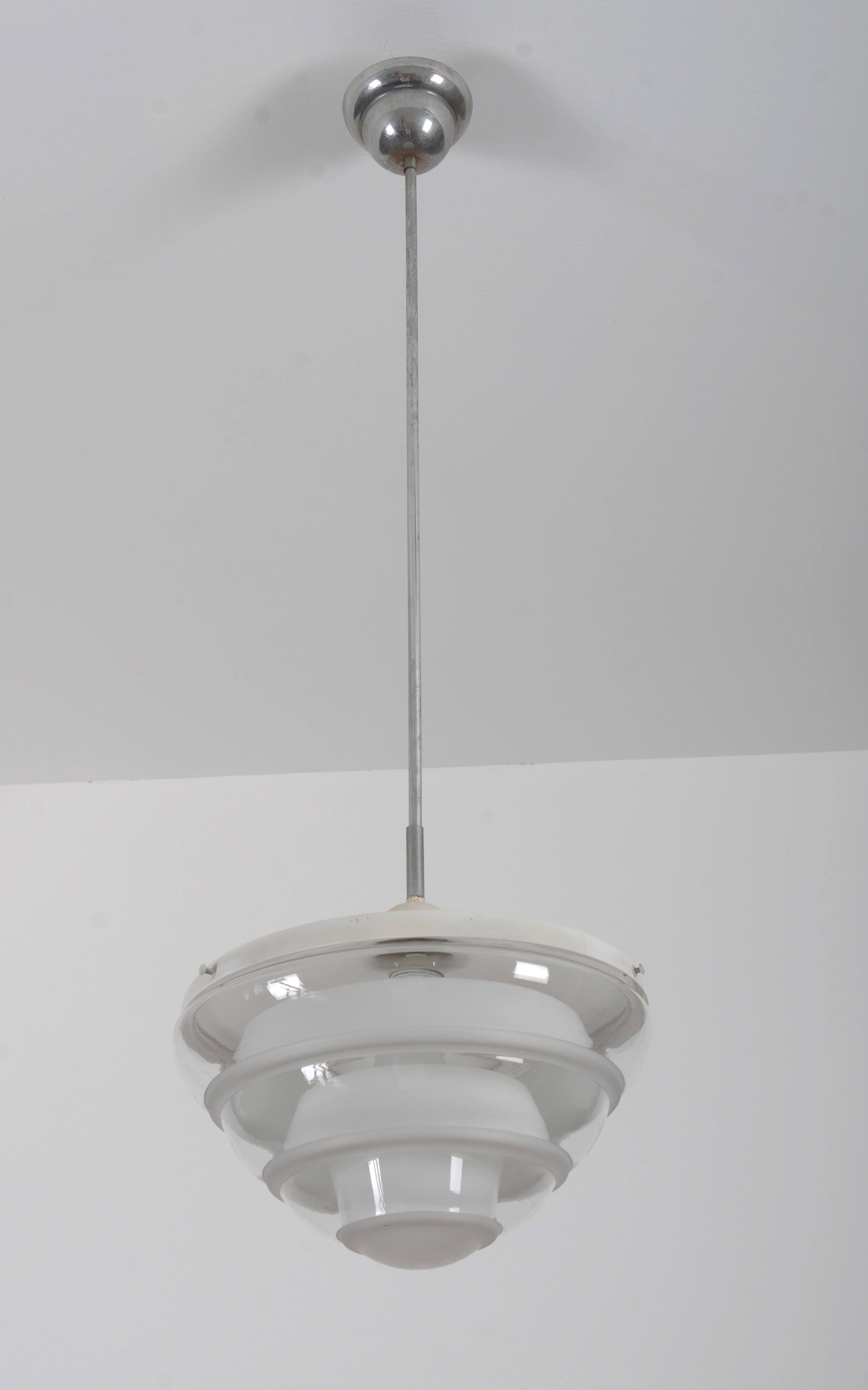 Opaline glass top with clear hemispherical buttom shade glass, frosted glass rings inside and steel fixing parts, designed by Karl Gustaf Lindesvärd in the 1930s for KG-Armaturen in Malmö Sveden. Fitted with E27 socket up to 100W. Up to 5 pieces