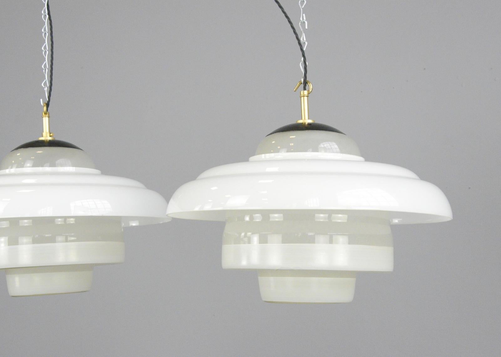 Bauhaus pendant lights by Mithras, circa 1930s

- Price is per light (2 available)
- Stepped opaline glass
- Opaline glass outer ring
- Comes with 100cm of black braided cable
- Comes with ceiling rose and chain
- Takes E27 fitting bulbs
-