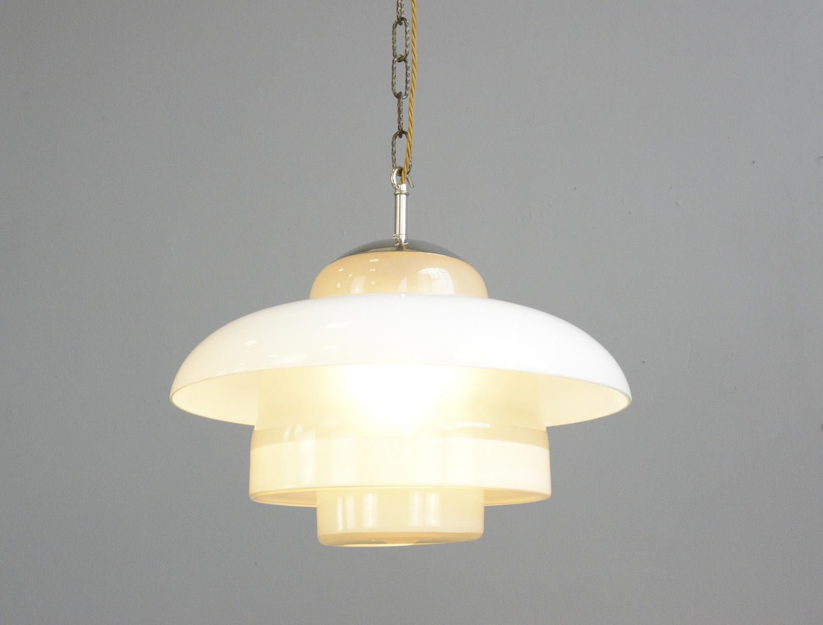 Bauhaus pendant lights by Mithras, circa 1930s

- Stepped opaline glass
- Opaline glass outer ring
- Comes with 100cm of goldbraided cable
- Comes with ceiling rose and chain
- Takes E27 fitting bulbs
- Produced by August Walther & Sohne,