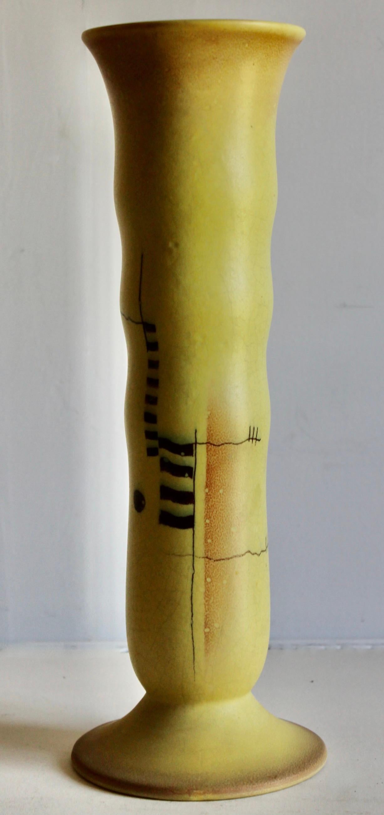 An unusually tall (15.5) and bright ceramic vase from one of the commercial potteries where Bauhaus or other related schools graduates to design and produce pottery in this new and radical style. The undulating vertical form,
bright yellow and