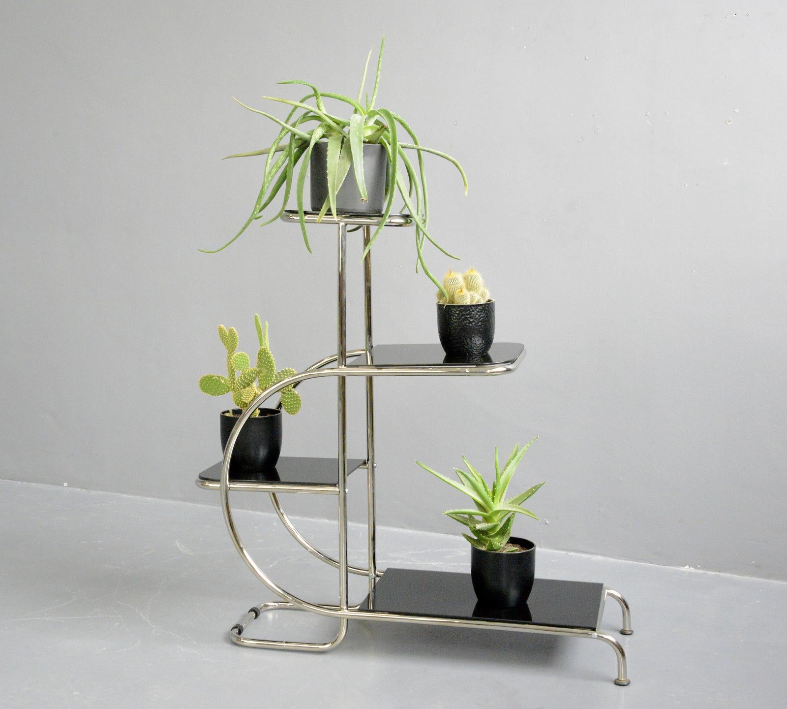 Bauhaus plant stand by Emile Guyot for Thonet Circa 1930s

- Chromed tubular steel
- Cantilever design
- Toughened black glass shelves
- Designed by Emile Guyot
- Produced by Thonet
- Czech ~ 1930s
- 92cm long x 34cm deep x 100cm