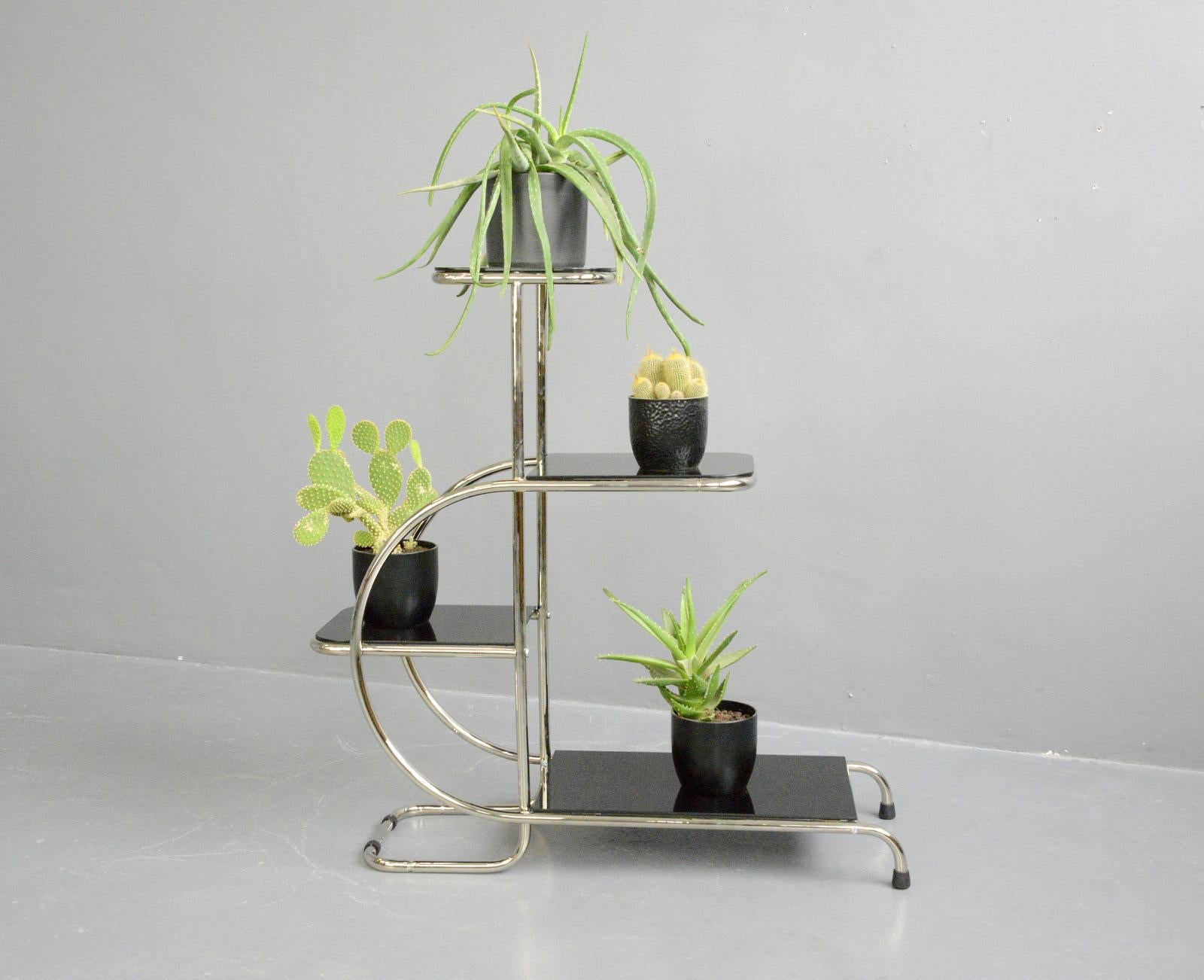 Bauhaus plant stand by Emile Guyot For Thonet, Circa 1930s

- Chromed tubular steel
- Cantilever design
- Toughened black glass shelves
- Designed by Emile Guyot
- Produced by Thonet
- Czech ~ 1930s
- 92cm long x 34cm deep x 100cm