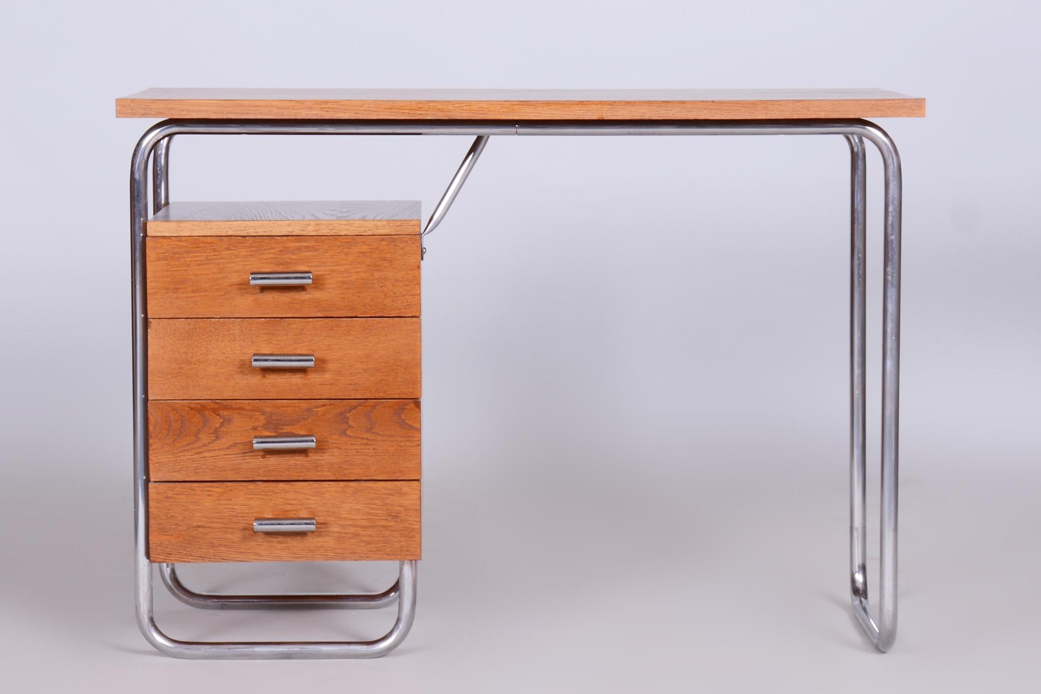 Restored writing desk with a frame in tubular chromed steel.

Designed by Robert Slezak in the 1930s.
Material: Oak, chrome-plated steel.

Wood is completely restored. 
Tubular steel with original chrome plating and patina. Fully cleaned.