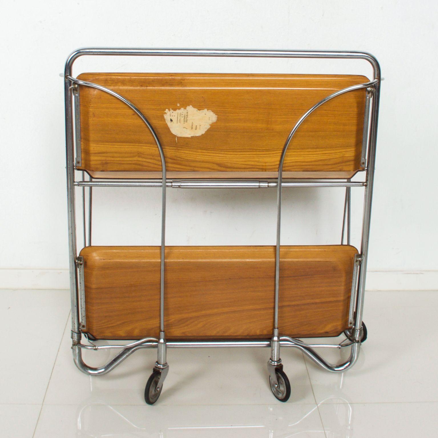 For your pleasure: Russian service tea cart foldable compact design trolley bar service bar by Bremshey AG, USSR, 1955

Two labels present. Unreadable.

Dimensions: 30 1/2