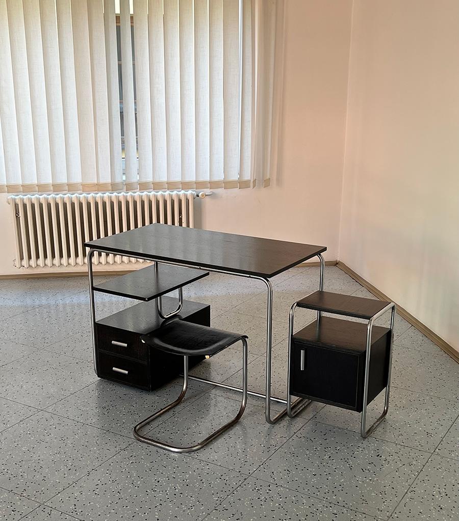 Bauhaus set featuring a tubular steel desk and stool as well as a storage cabinet, all made in Czechoslovakia, 1930s.

Date of manufacture: 1930s
Origin: Czechoslovakia
Material: chrome-plated tubular steel, wood
Dimensions: (table) H 77 cm x W 110