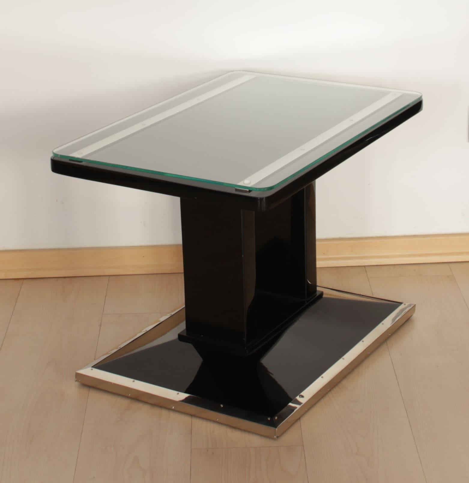 Wonderful, rare and high-qulaity restored side table / former luggage table. 
The table was used as a luggage table in the 1920/30s with steel trims at the top for placing a suitcase. We fully restored it with a new black lacquer and glass plate on