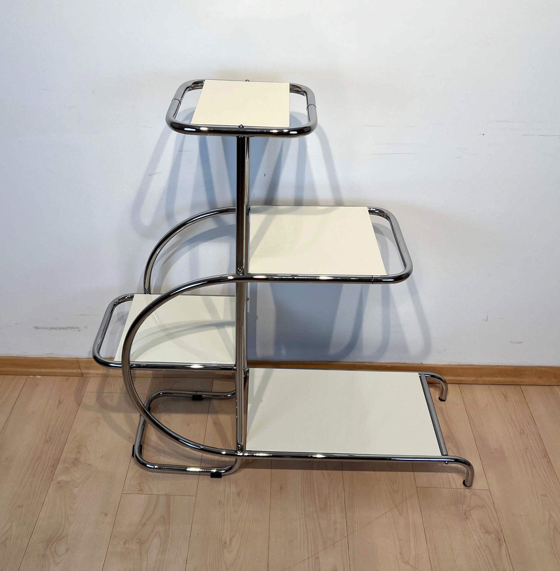 Bauhaus steeltube Etagere / shelf from Germany about 1930.
 
Original furniture from the 1930s, completely restored.
Newly galvanized / nickel-plated steeltubes and screws and new creme-white lacquer on wooden shelves. 
 
Design: Emile Guyot,