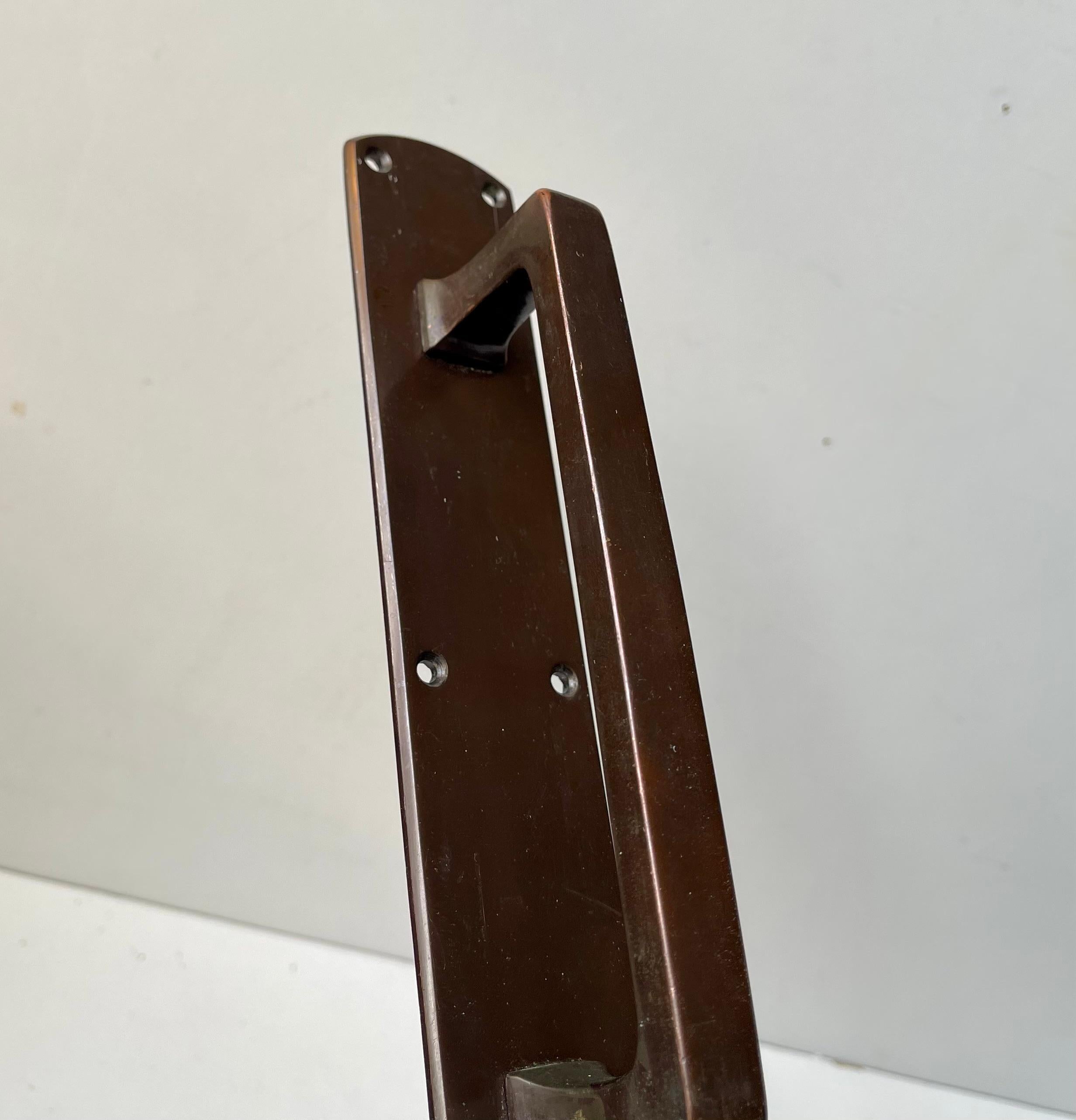 Two sets of patinated bronze gate or push/slide-door handles that was salvaged from a Danish Bank called Andelsbanken during the 1930s. The two sets are suitable for both in- or outdoor use. 

Measurements: H: 25.5 cm, Width: 4.5 cm, Depth: 5 cm.