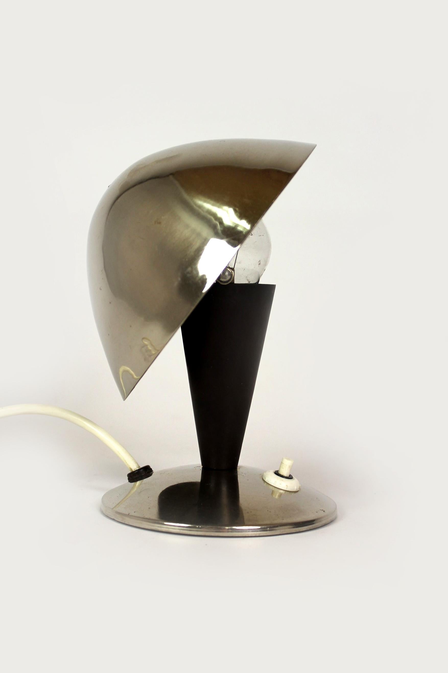 This Bauhaus style table lamp was produced by ESC in the 1940s in Czechoslovakia. The lamp is in working order, preserved in original, good condition with a visible patina.