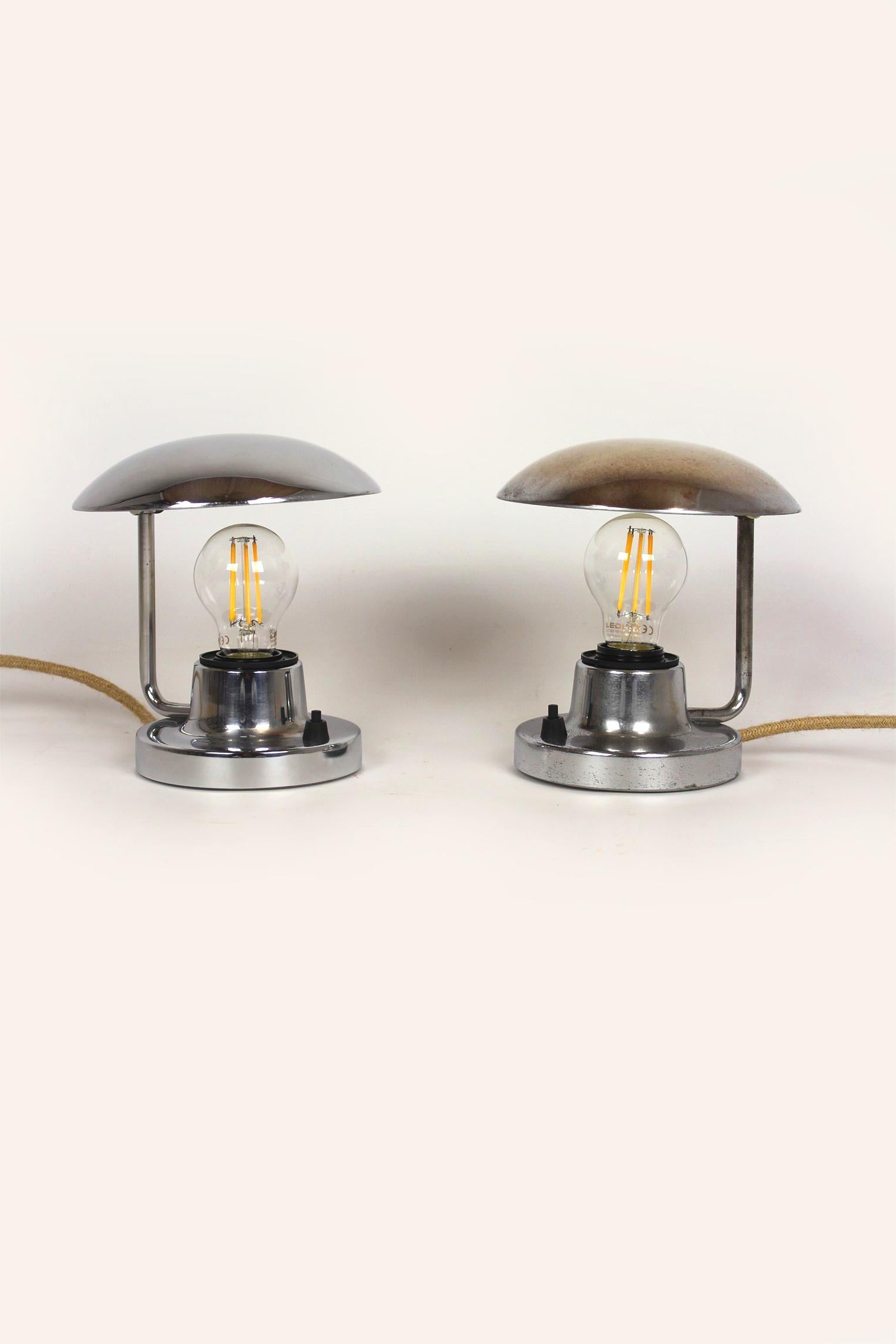 These chrome table lamps (type 1195) in the Bauhaus style were manufactured by Napako in the 1940s in the Czech Republic. The lamps have new electrical installations and retro-style jute wires. Fully functional, shipped with the bulbs shown in the