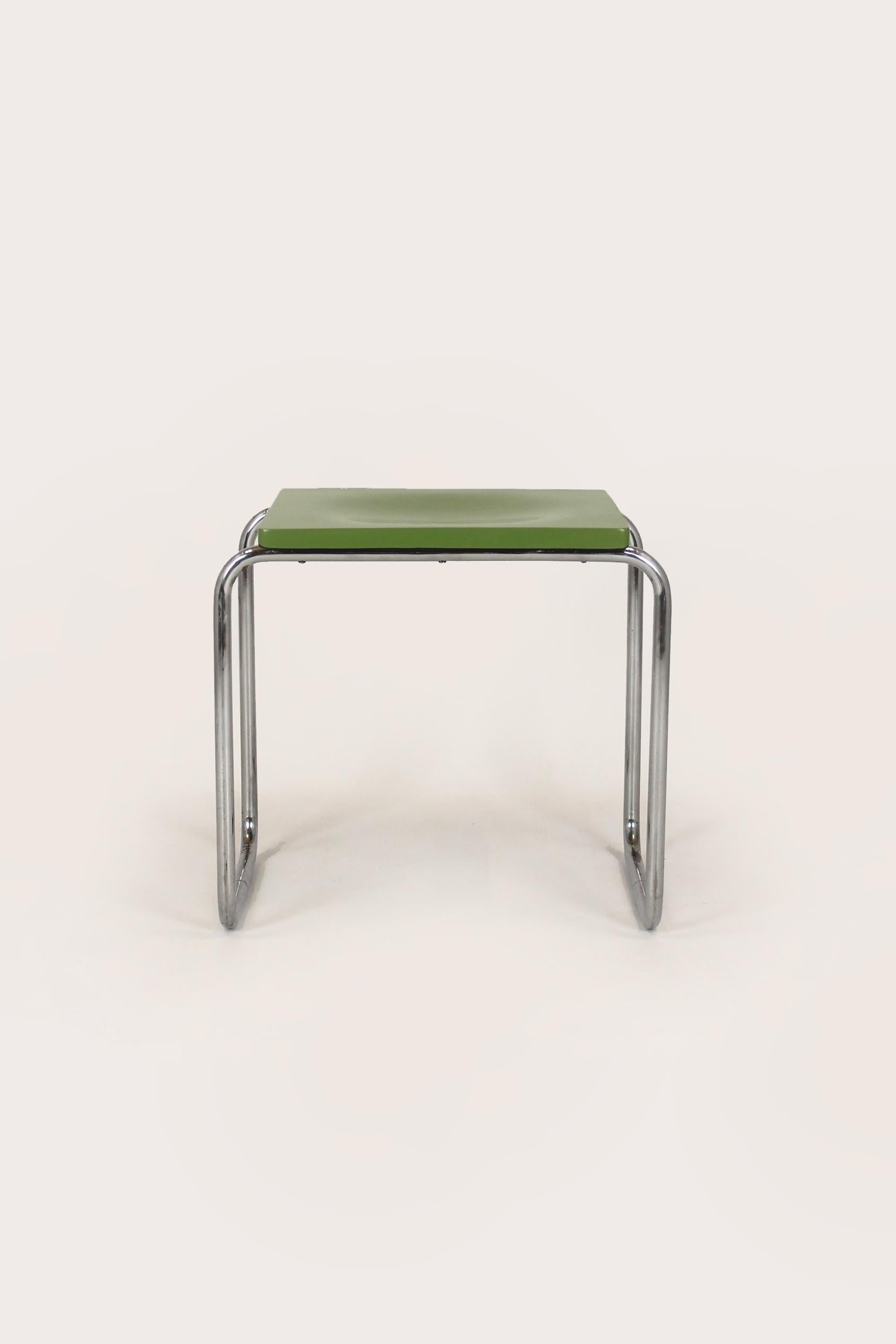 This Bauhaus style stool was manufactured by Slezak in the Czech Republic in the 1930s. Made of chromed tubular steel with a molded plywood seat. Steel elements in good condition with visible patina, seat repainted in original color, well-preserved