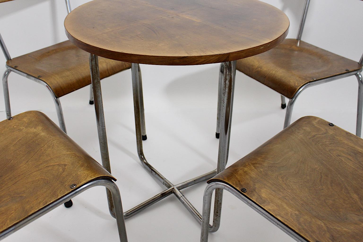 Bauhaus style vintage dining room set consisting of four ( 4 )  dining chairs and one ( 1 )  dining table from chromed tubed steel and plywood 1930s Germany.
A beautiful vintage dining set with 4 dining chairs and one matching circular dining table