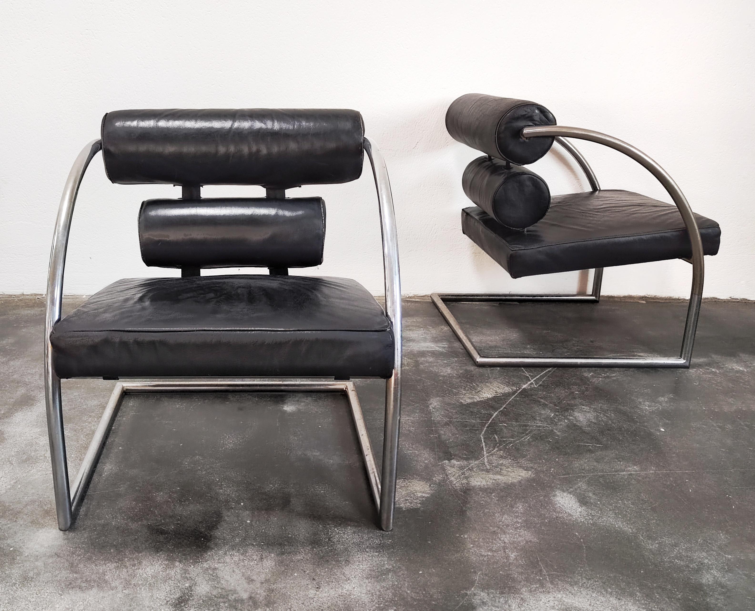 In this listing you will find a gorgeous, geometrical armchair done in leather, with tubular chrome frame. The armchair features the backrest with two cylinders and the square seat, creating harmonious design typical for the Bauhaus. Two armchairs