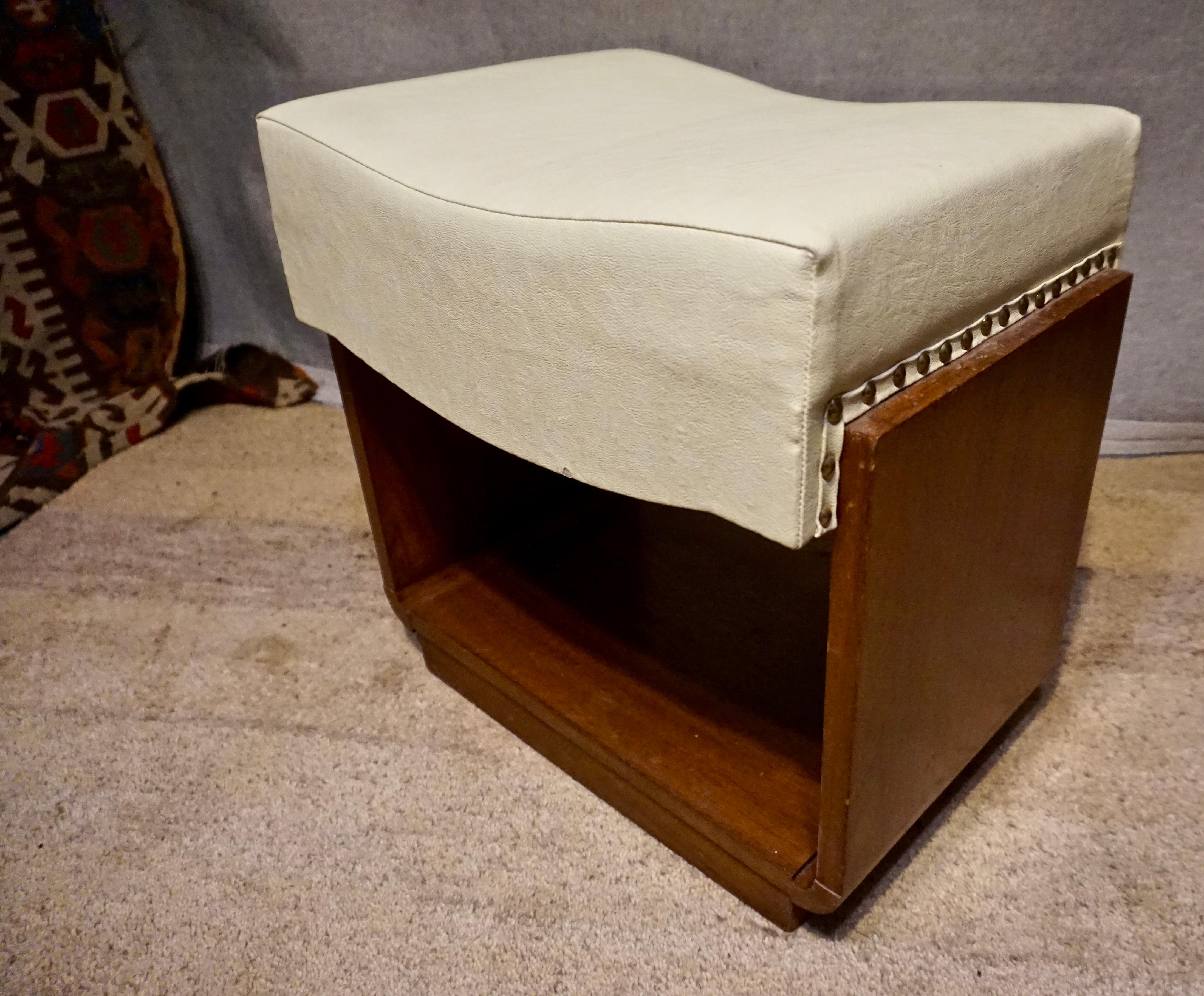 Clean lines and solid wood midcentury stool in good condition with leatherette upholstery,

circa 1950s.