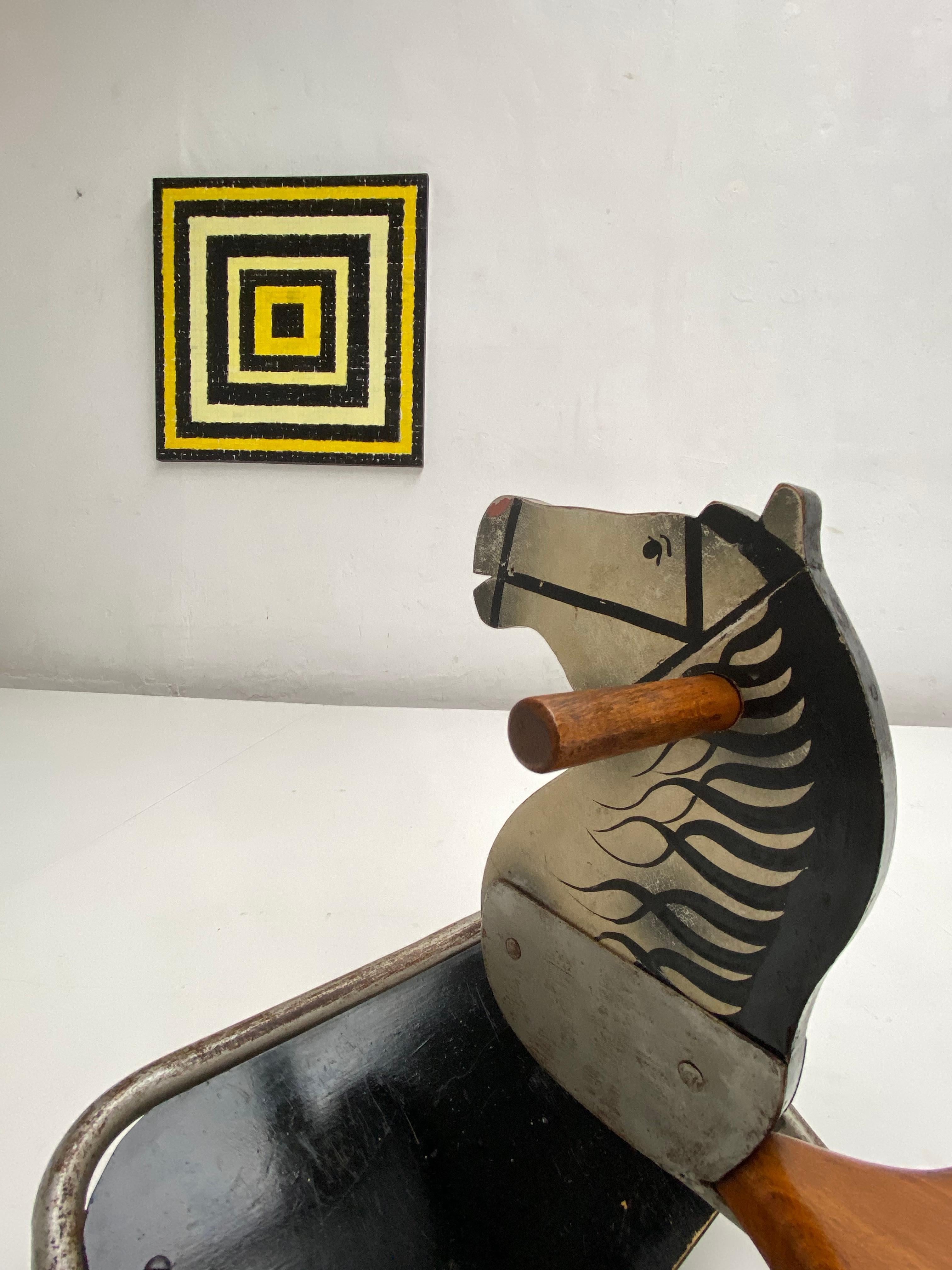Very nice and original vintage condition rocking horse in Bauhaus style, circa 1940.

This rocking horse was made to last

All handmade in Solid round metal and solid wood seating with a beautifully painted horse head

Nice detail are the old