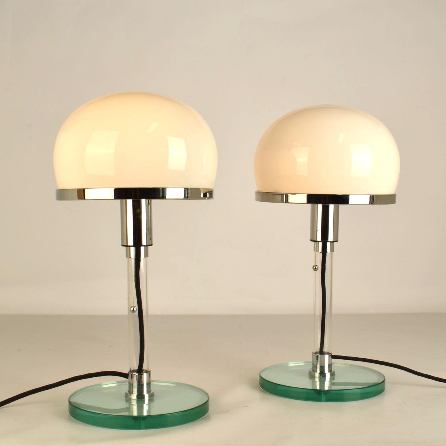 Pair of iconic Pair of Bauhaus style table lamps after the WG24 table lamps by Prof. Wilhelm Wagenfeld (Designed 1924), a leading figure of the Bauhaus movement., Germany. These are made in the 1980-90's after the original design. 
These lamps are