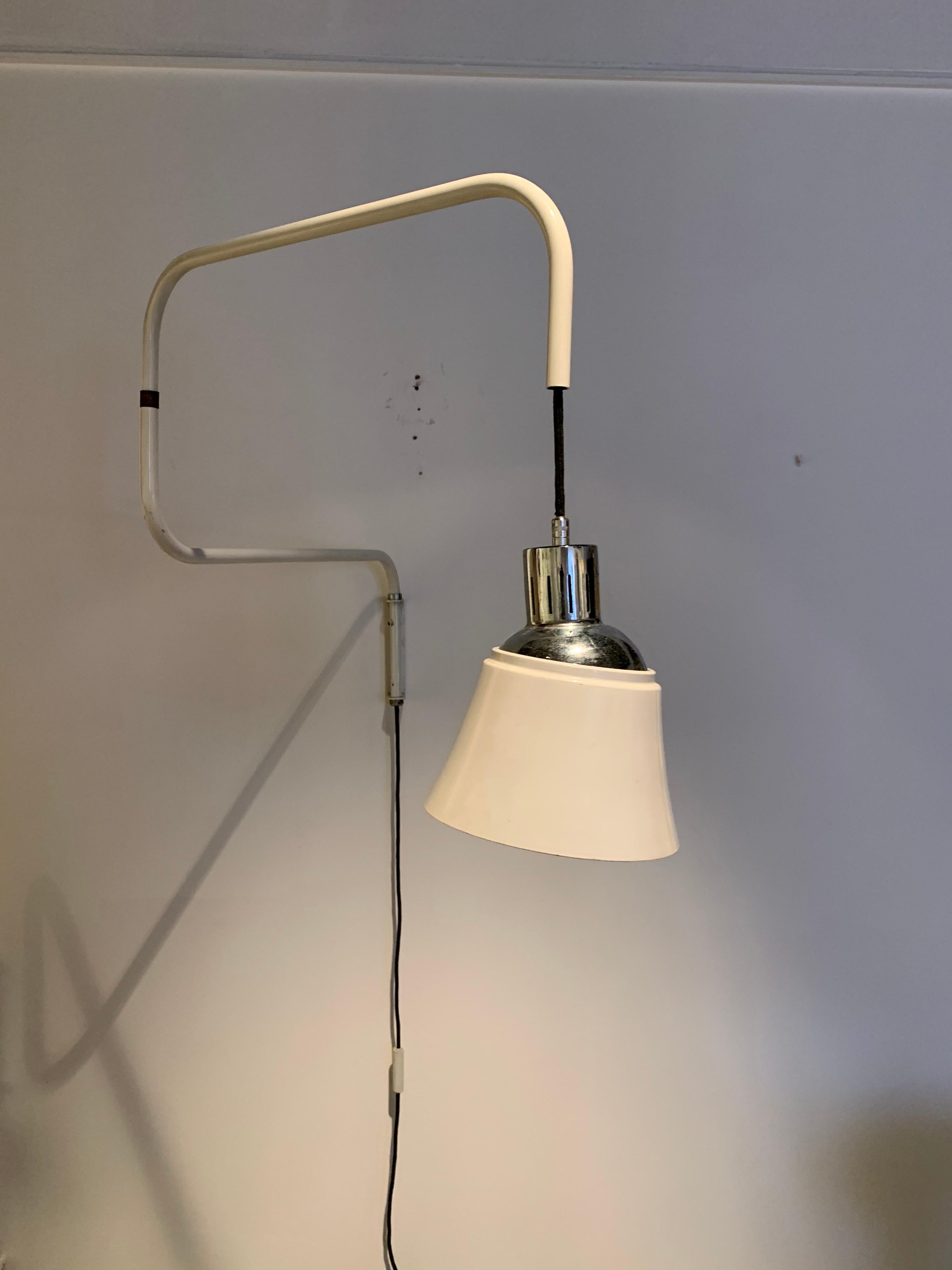 The Original model was designed and prouduced in the 1930s by the German designer Heinrich Bormann. This model dates circa 1950. It is the second edition edited the Italy Company Ugo Pollice. 
The lamp has its original wiring.