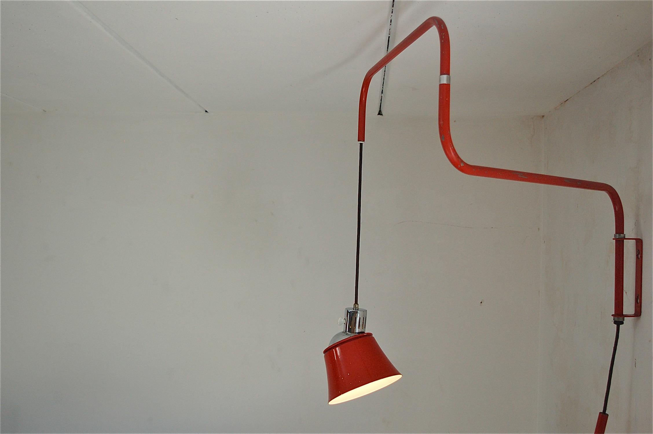 Wall-mounted swing arm wall light designed by Heinrich Siegfried Bormann in 1930. Plugs into the wall and the height of the shade can be adjusted thanks to a counterweight. The shade rests on the chrome lamp fitting. To change the direction of the