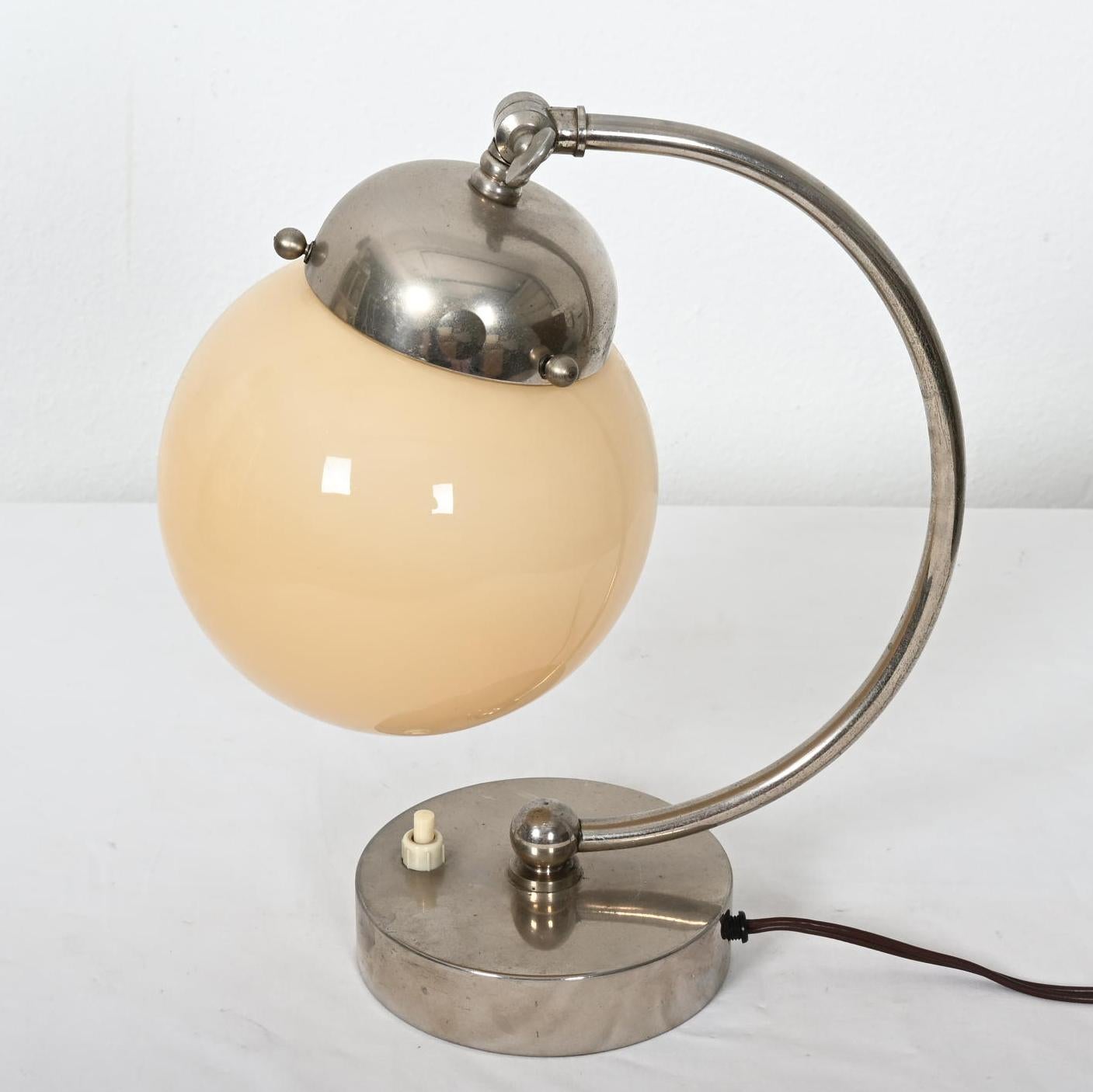 Brass frame nickel-plated fitte with one e27 socket and opaline glass globe shaped shade. Made in the 1930 in Austria.
