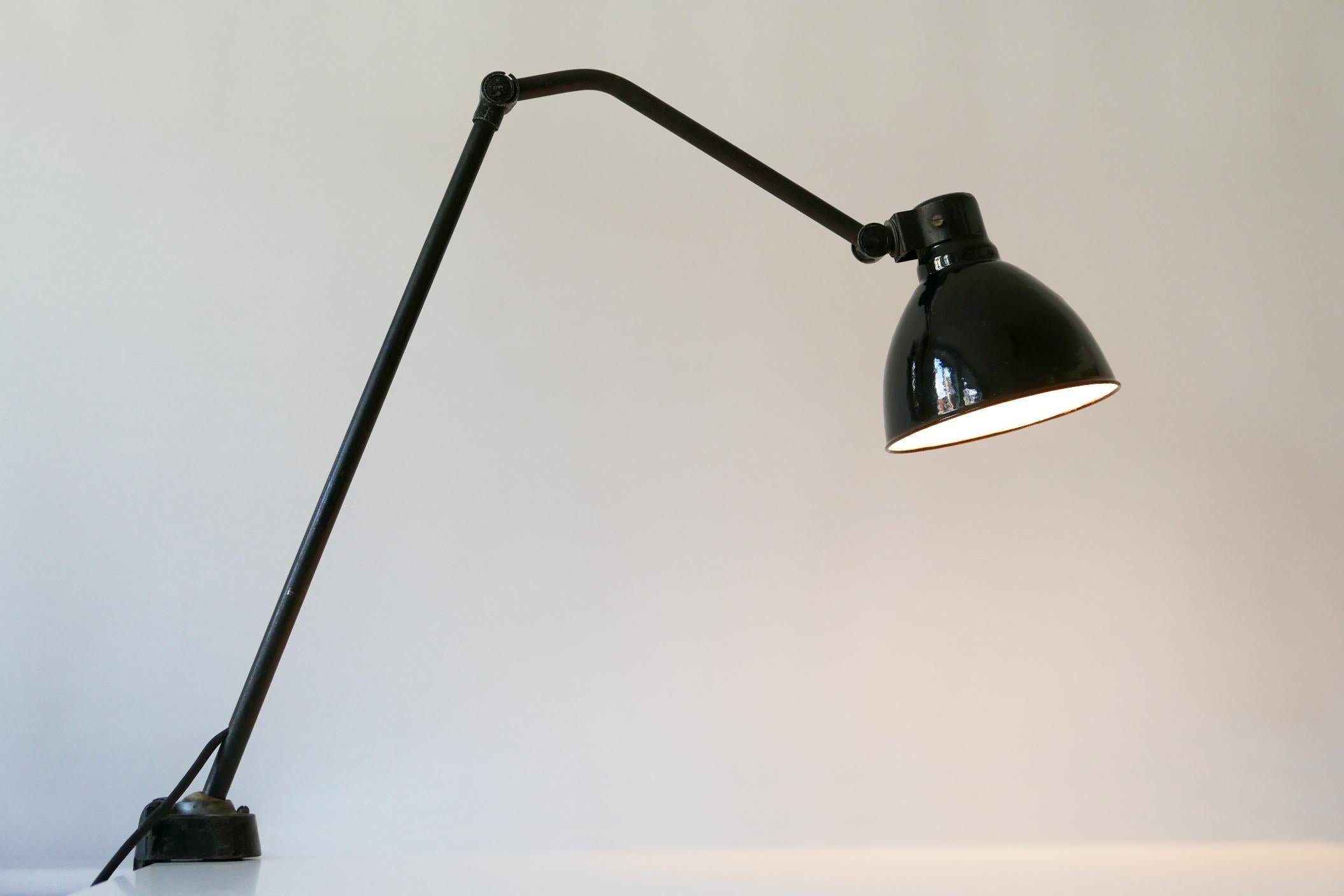 Extremely rare and articulated Bauhaus or Modernist task lamp or clamp table light. Designed by Peter Behrens for AEG, Germany, 1920s.

Executed in black enameled metal, the lamp needs 1 x E27 Edison screw fit bulb, is wired and in working