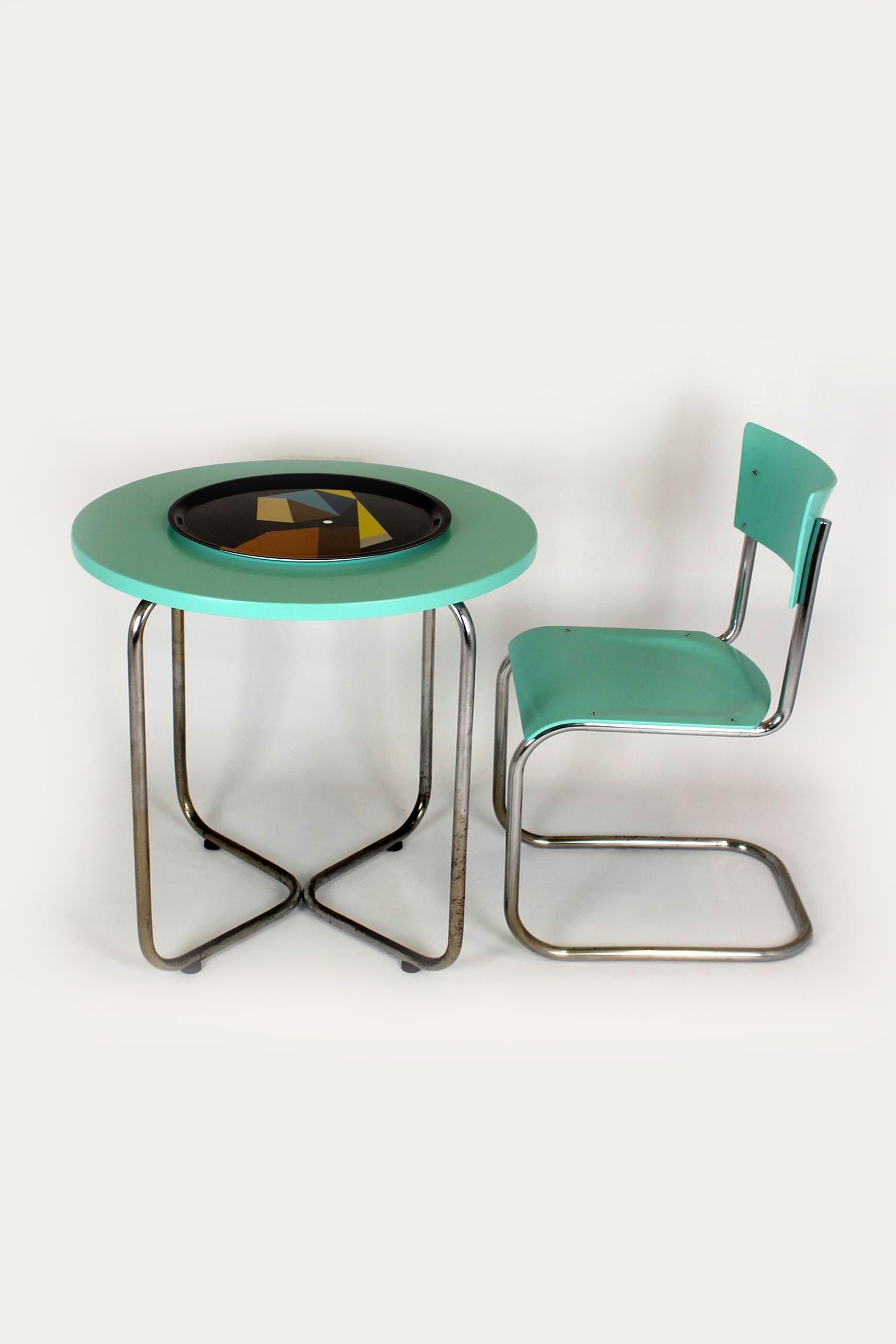 This Bauhaus style set was produced in the 1930s in Czechoslovakia. The set consists of a round table and one chair (S43) designed by Mart Stam. The furniture is made of chrome tubular steel and wood and was manufactured probably by Thonet or one of