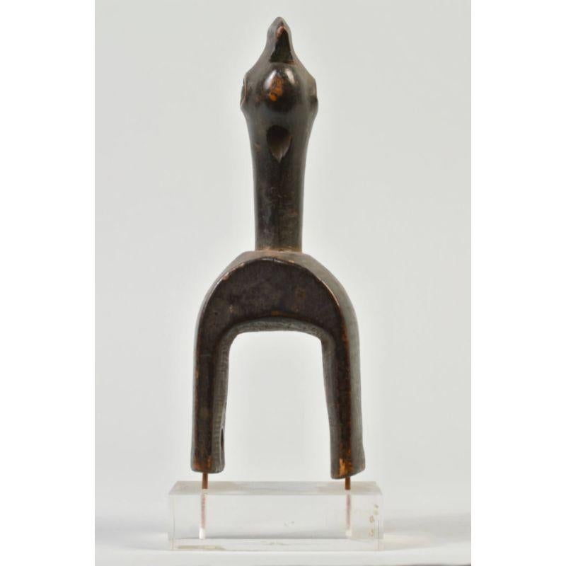 Baule ground-hornbill Heddle pulley in wood.

Baule heddle pulley carved in the form of an Abyssinian ground-hornbill. Called calao in French, hornbills are particularly attractive to humans for their propensity to form monogamous pairs, the