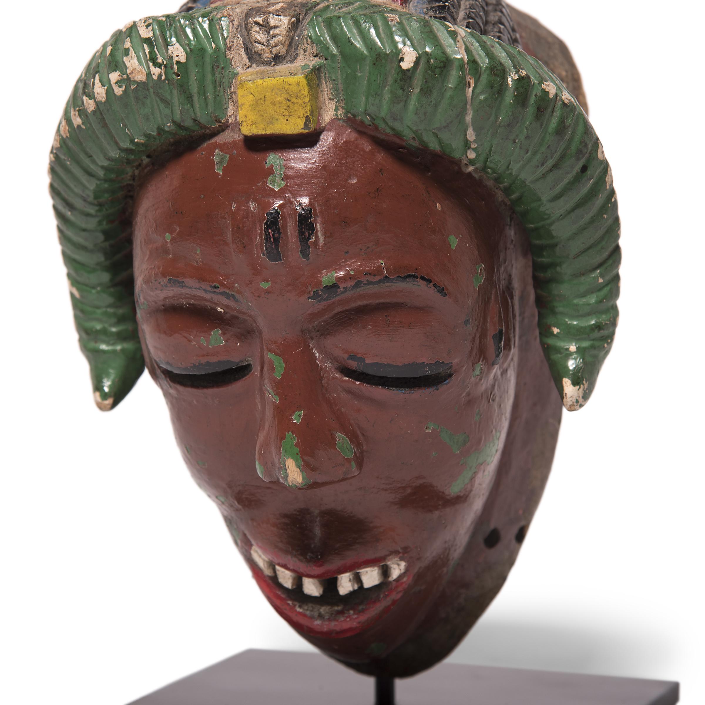 To ward off evil and exert positive influences on the spirit world, the Baule people engage in a daylong masquerade known as the Goli. A sequence of four masks are donned during the performance, with the last and most important being the kpan, or