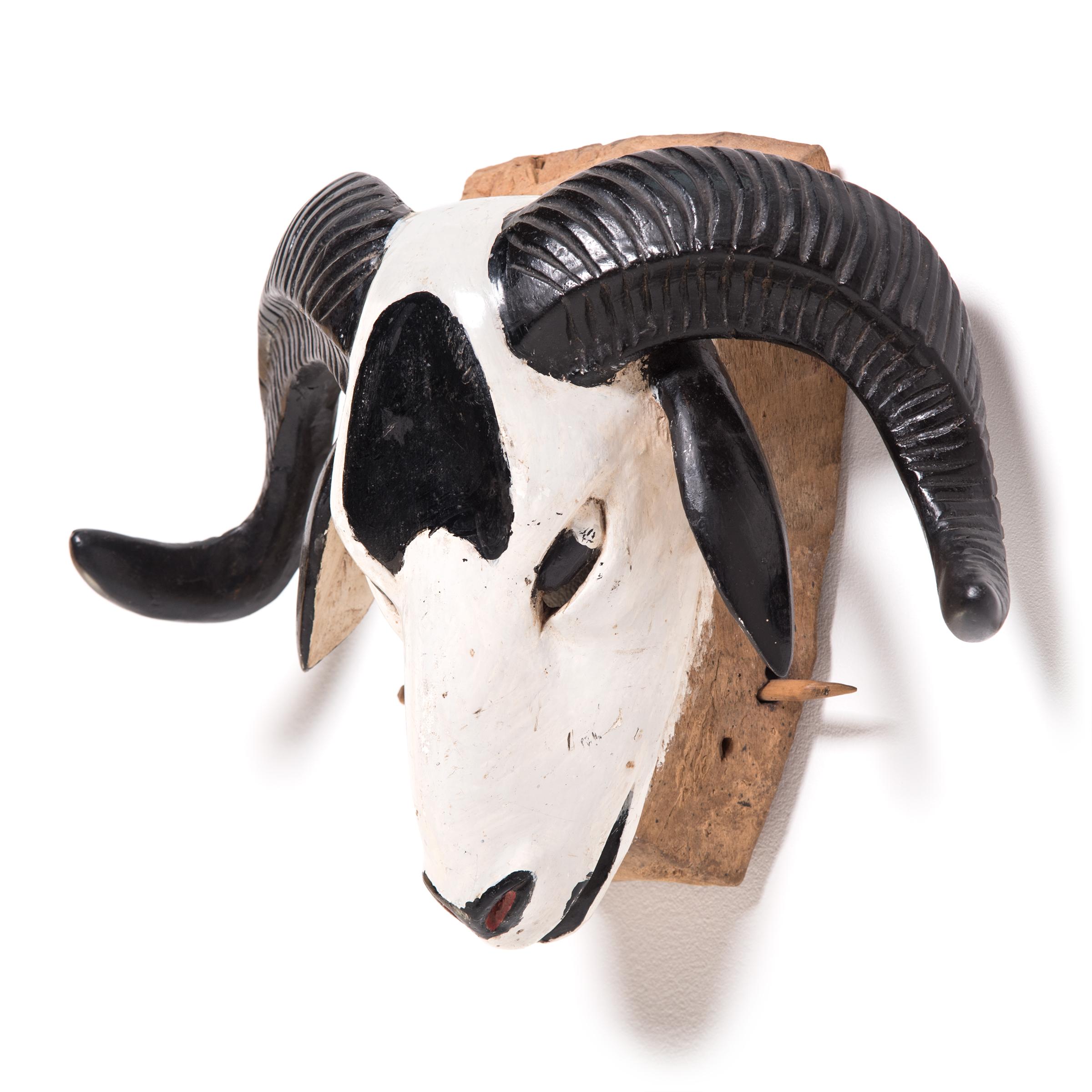 The Baule people of the Ivory Coast used ram masks in secular, public performances. Realistically carved, and wonderfully decorated, they were designed to draw attention and enhance the festival atmosphere. The white on black of this example