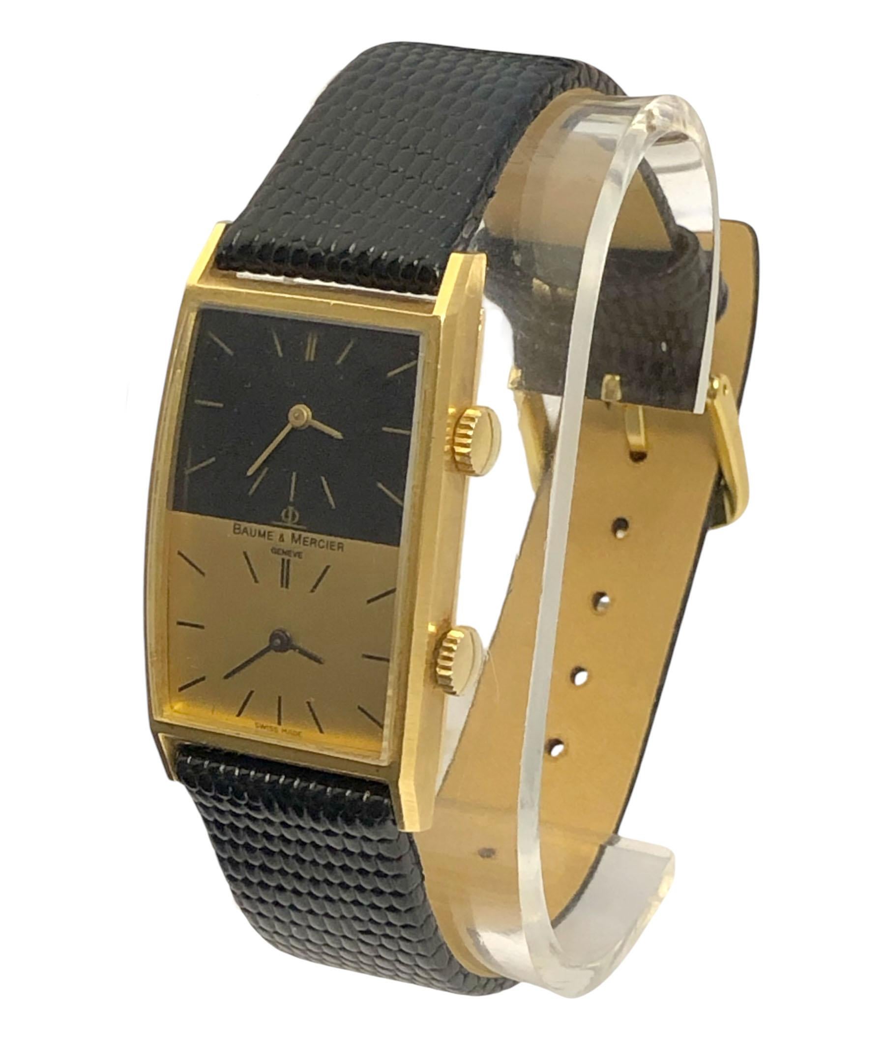 Circa 1970s Baum & Mercier Duel Time Zone Wrist Watch, 41 M.M X 23 M.M 18k Yellow Gold 2 Piece case, Glass crystal, Black and Gold Dial, 2 independent Mechanical, Manual wind movements. New Hadley Roma Black Lizard grain strap. Recently serviced and