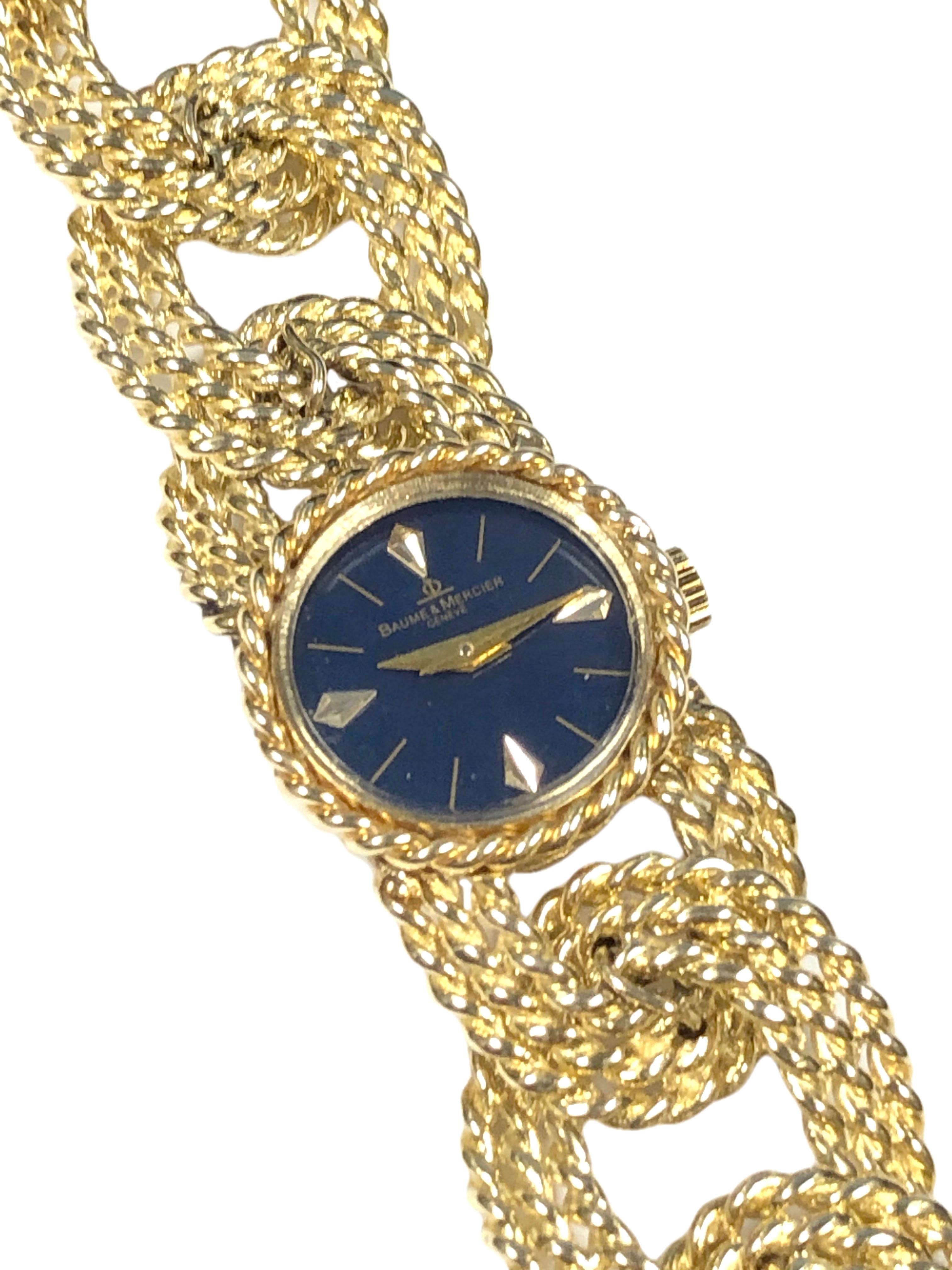 Circa 1960s Baum & Mericer Ladies Bracelet Wrist Watch, 20 M.M. 14K yellow Gold 2 Piece case with a Twisted Rope design bezel, 17 Jewel, Mechanical, Manual wind movement. Navy Blue Enamel dial with raised Gold markers. Twisted Rope design