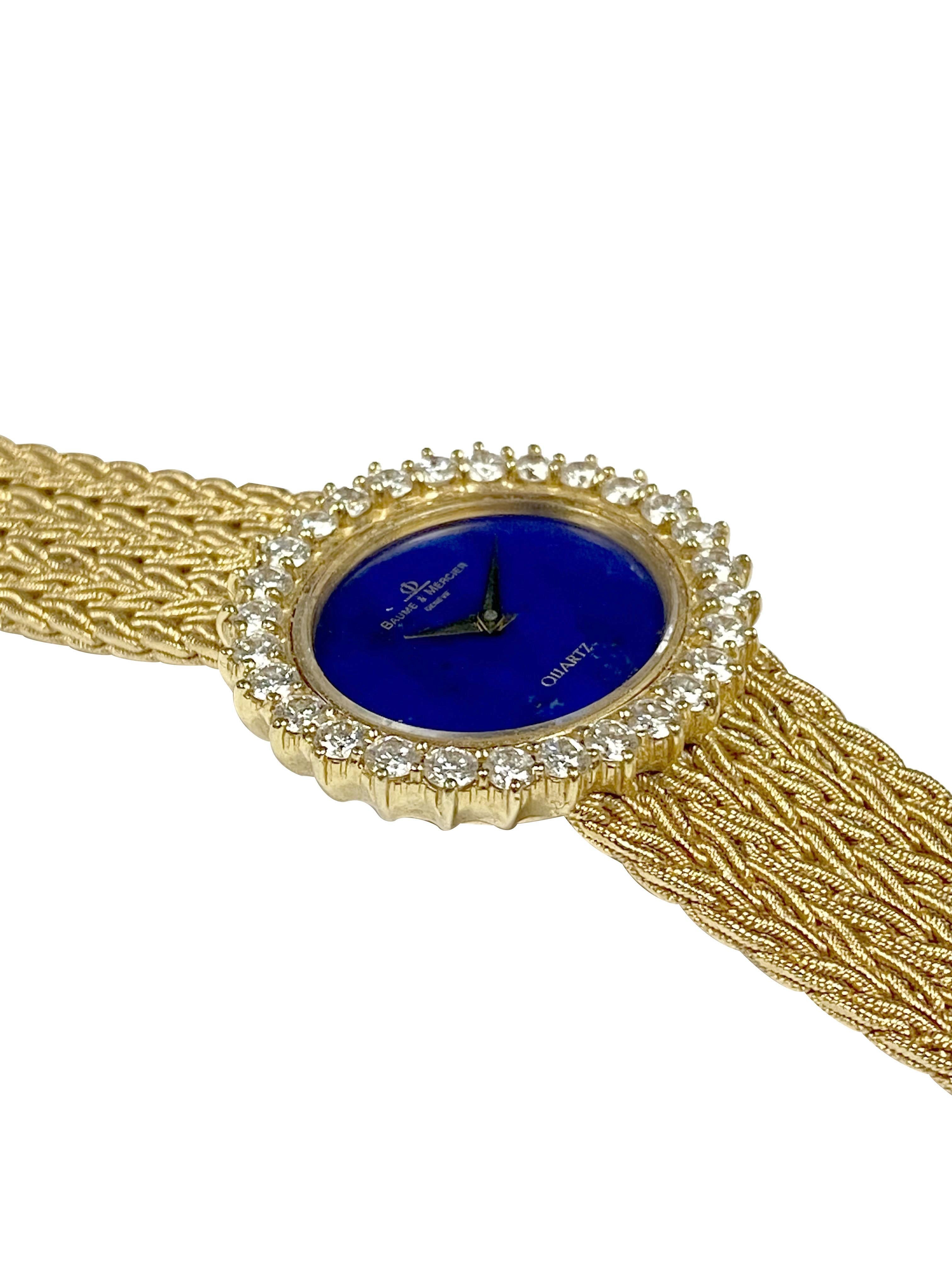 Circa 1980 Baum & Mercier Ladies Wrist Watch, 30 X 27 M.M. 2 piece 18K Yellow Gold case with a Bezel of Round Brilliant cut Diamonds totaling 2 Carats and Grading as G in Color and VS in Clarity. Lapis Lazuli Dial and a Sapphire crown. 17 Jewel
