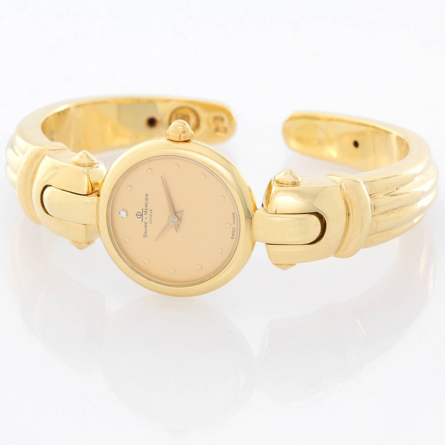 Baume & Mercier 18K Yellow Gold Vintage Watch -  Quartz. 18K Yellow gold ( 22 mm ). Champagne dial with dot hour markers. 18K Yellow gold bracelet with hinged clasp. Pre-owned with Baume & Mercier leather pouch.