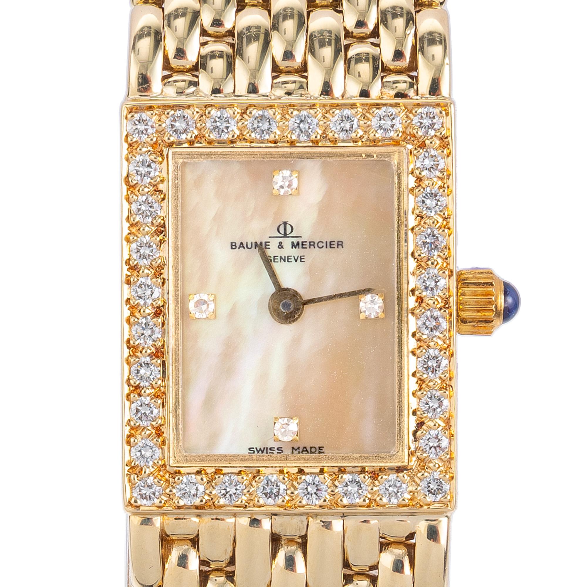 This is an elegant 14k yellow gold Baume and Mercier ladies wristwatch with a 32 round bright white diamond bezel, 4 single cut diamond mother of pearl diamond dial, mesh bracelet, and quartz movement. This is a statement timepiece that has a