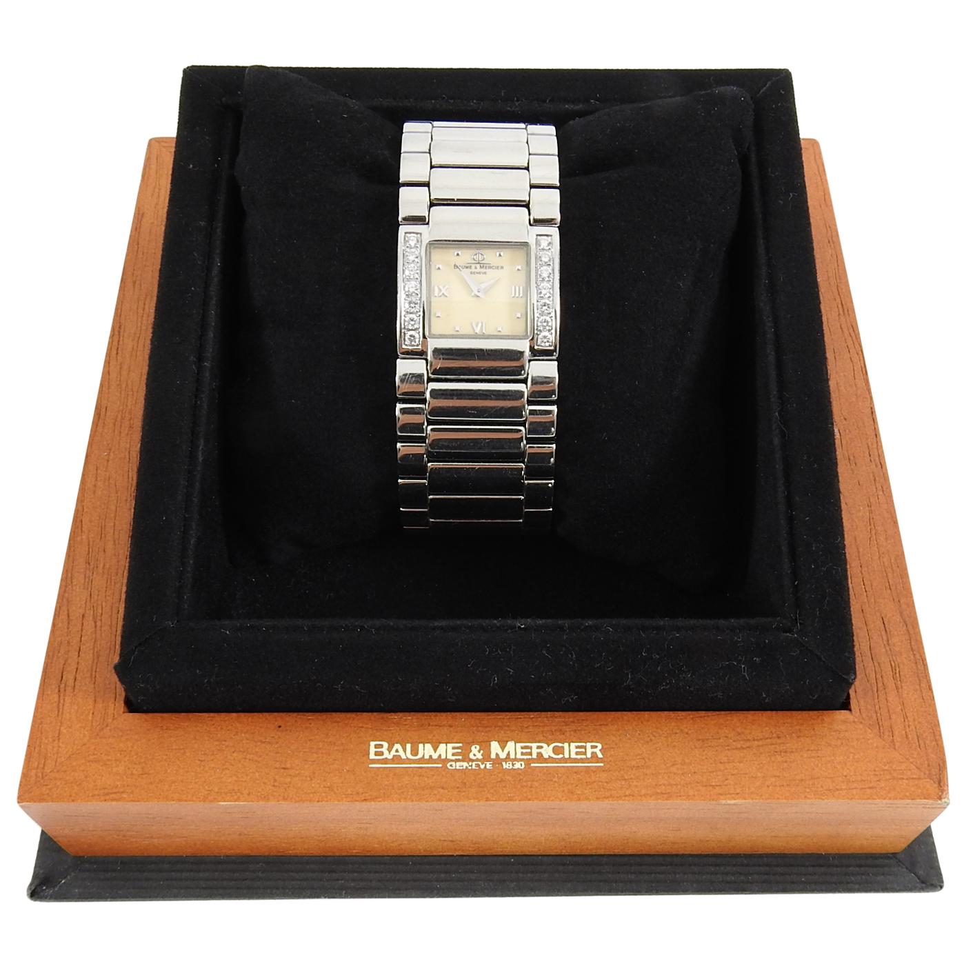 Baume and Mercier Catwalk Stainless Diamond Tank Watch.  23 mm wide face with stainless links. and 14 diamonds.  Includes box and booklet.  Currently sized to fit a 6.5