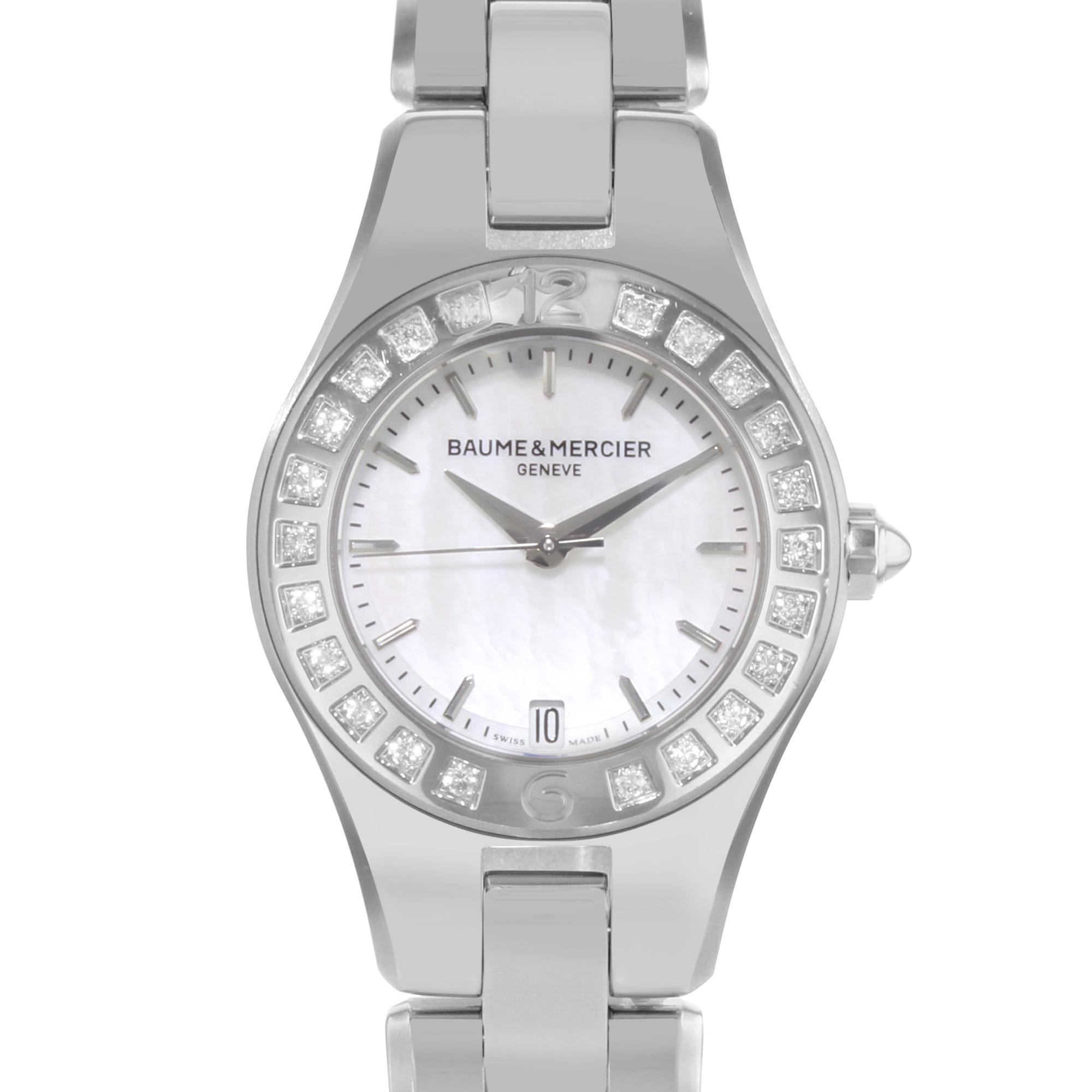 This never been worn  Baume et Mercier Linea MOA10078 is a beautiful Ladies timepiece that is powered by a quartz movement which is cased in a stainless steel case. It has a round shape face, date dial, and has hand sticks style markers. It is