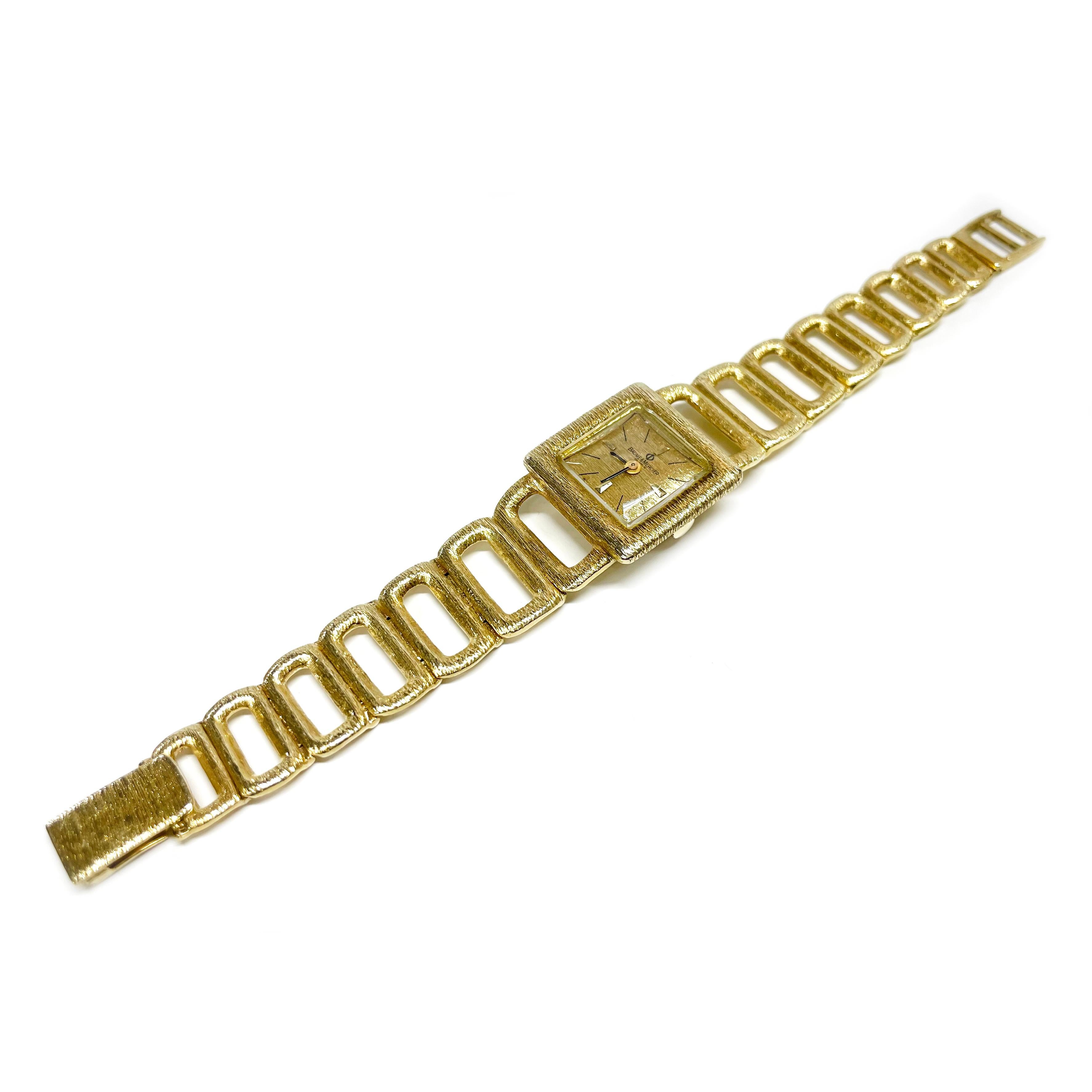 14 Karat Baume et Mercier Yellow Gold Wristwatch. The watch features a square-faced dial framed in a gold bezel and gold dial with open gold links all in a satin stone finish. The watch has baton-style hour and minute hands. The link bracelet band