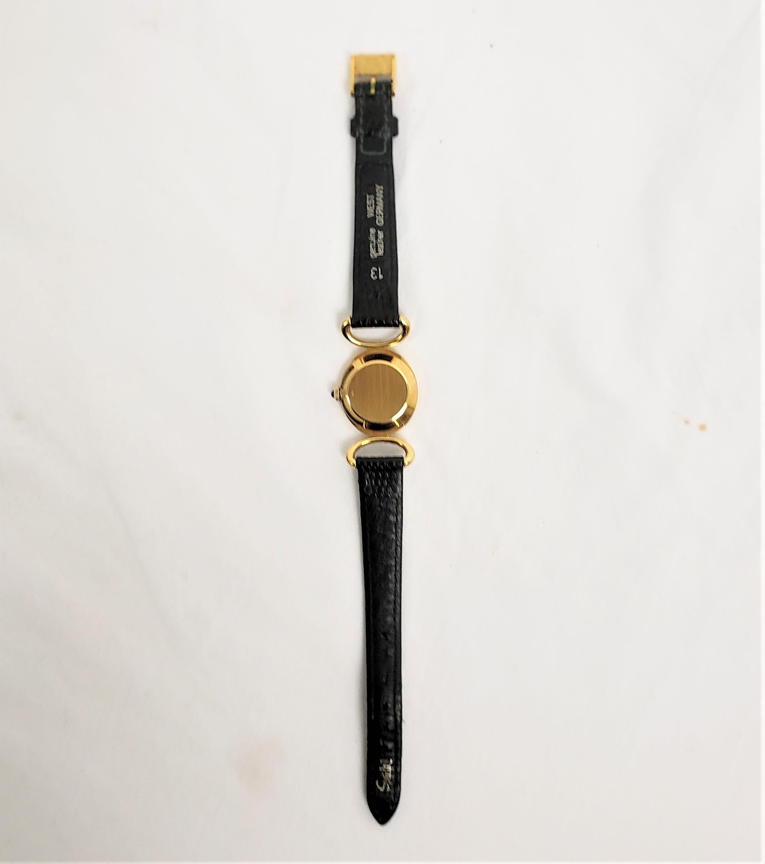Baume Mercier 18 Karat Gelbgold Damenarmbanduhr mit Original Lederband (20. Jahrhundert) im Angebot