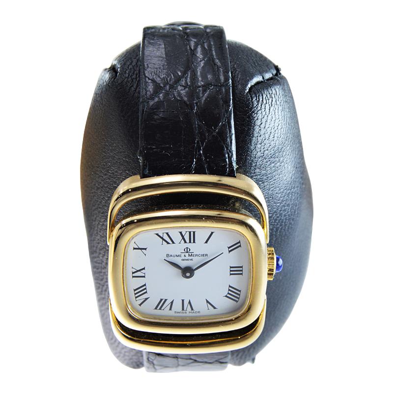 FACTORY / HOUSE: Baume Mercier 
STYLE / REFERENCE: Mid Century Modern
METAL / MATERIAL: 18kt Yellow Gold
CIRCA / YEAR: 1960's
DIMENSIONS / SIZE: Length 30mm x Width 24mm
MOVEMENT / CALIBER: Manual Winding / 17 Jewels 
DIAL / HANDS: Original White