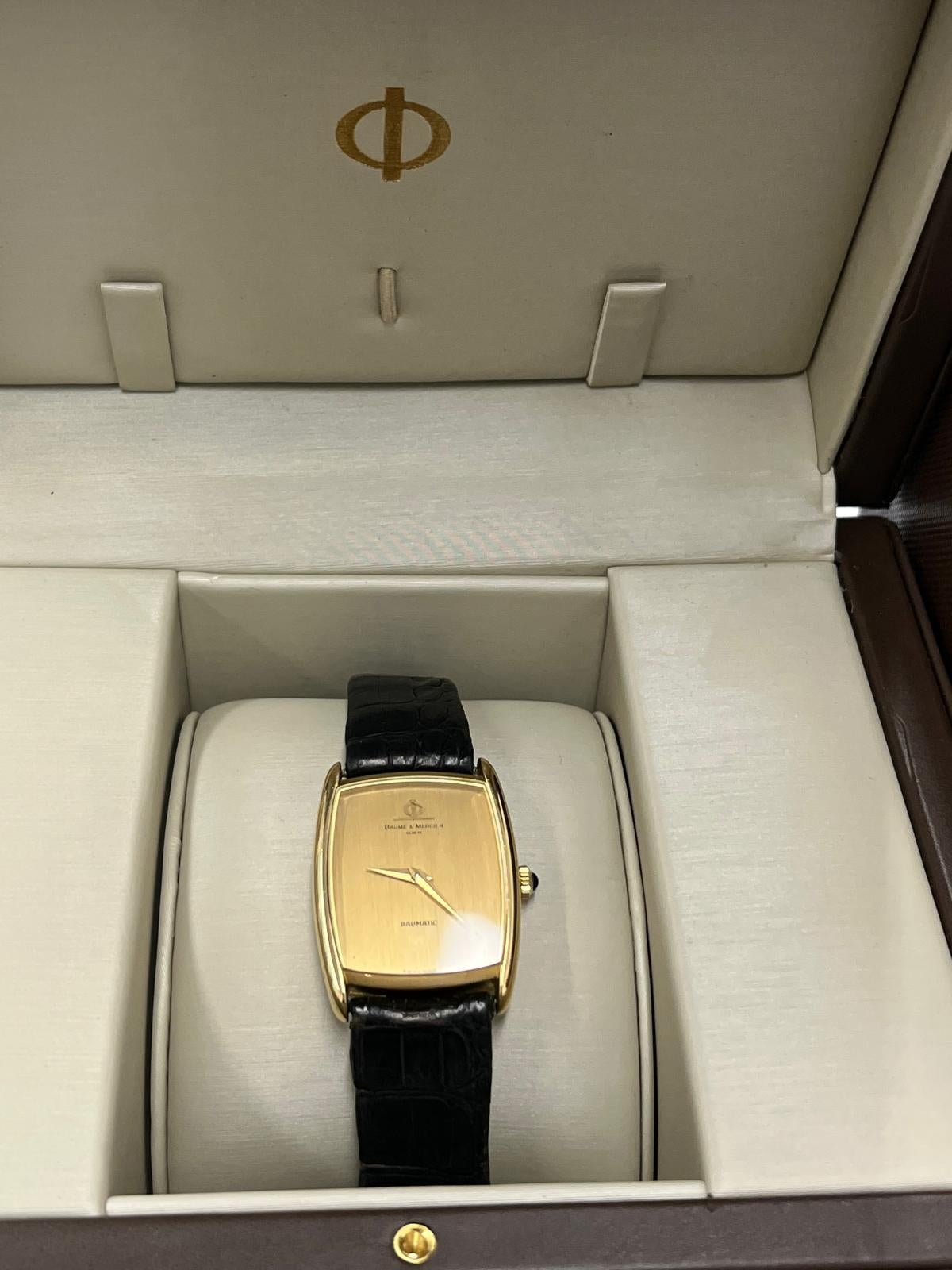 A classic and sophisticated Baume & Mercier Baumatic Watch, crafted in solid 18ct yellow Gold. This elegant timepiece embodies fine Swiss watchmaking, offering a perfect blend of luxury and precision. 
A must-have for collectors and enthusiasts of