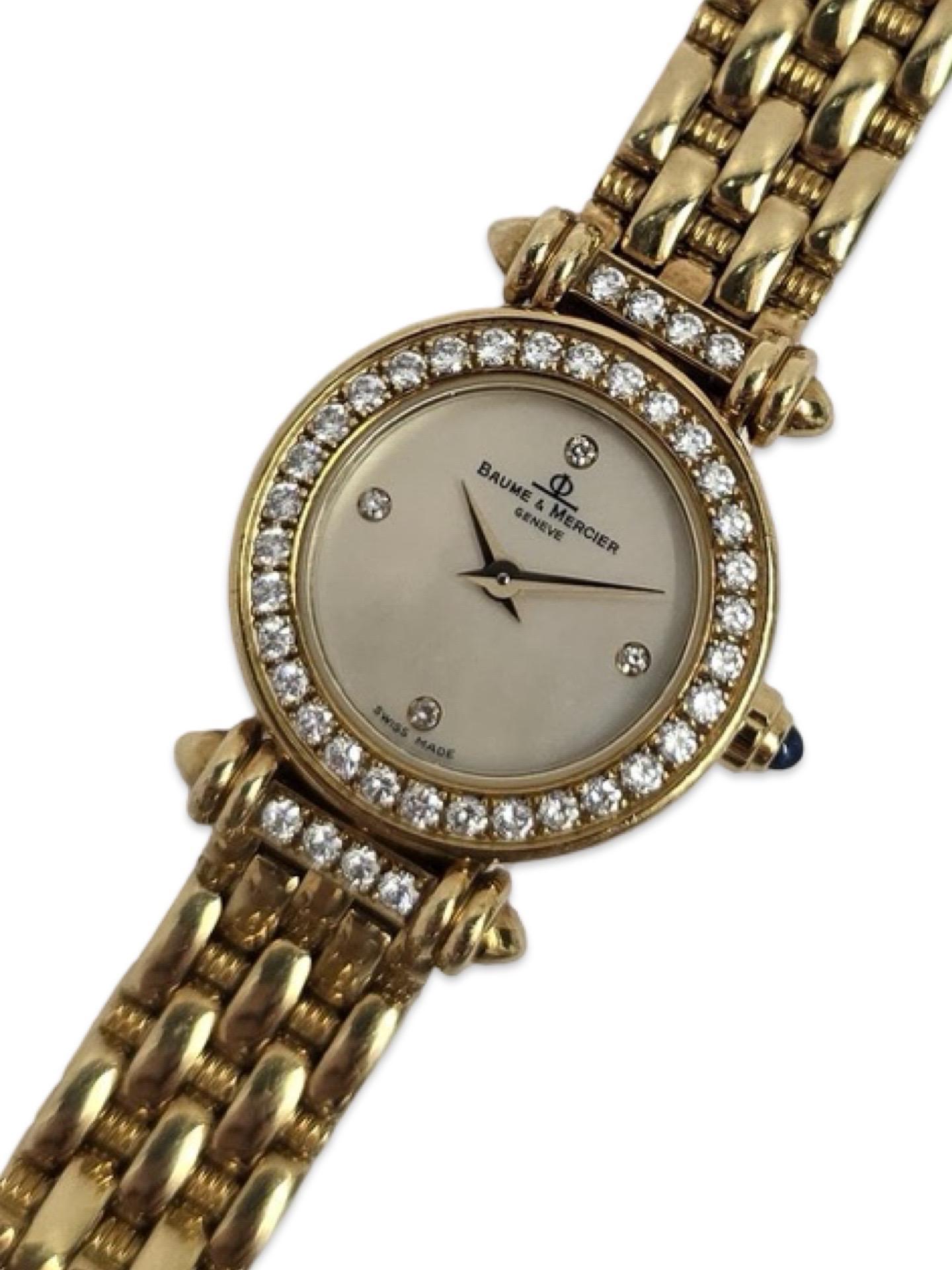 A refined and feminine timepiece by Baume & Mercier, this vintage Swiss-made ladies watch is crafted entirely in solid 18K yellow gold. Measuring a delicate 20mm in diameter, the round case is elegantly framed with a brilliant diamond-set bezel,