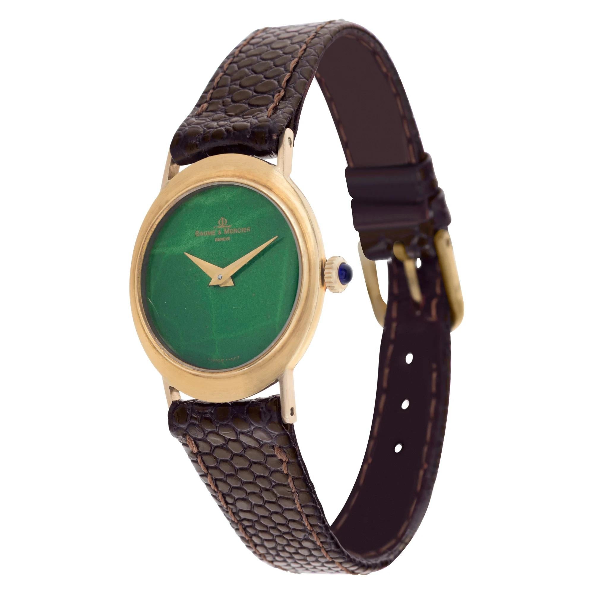 Vintage Baume & Mercier in 18k with green malachite dial. Manual wind. Case size 26.5 mm x 24 mm. Ref 374452. Fine Pre-owned Baume & Mercier Watch.

Certified preowned Vintage Baume & Mercier 374452 watch is made out of yellow gold on a Brown Lizard