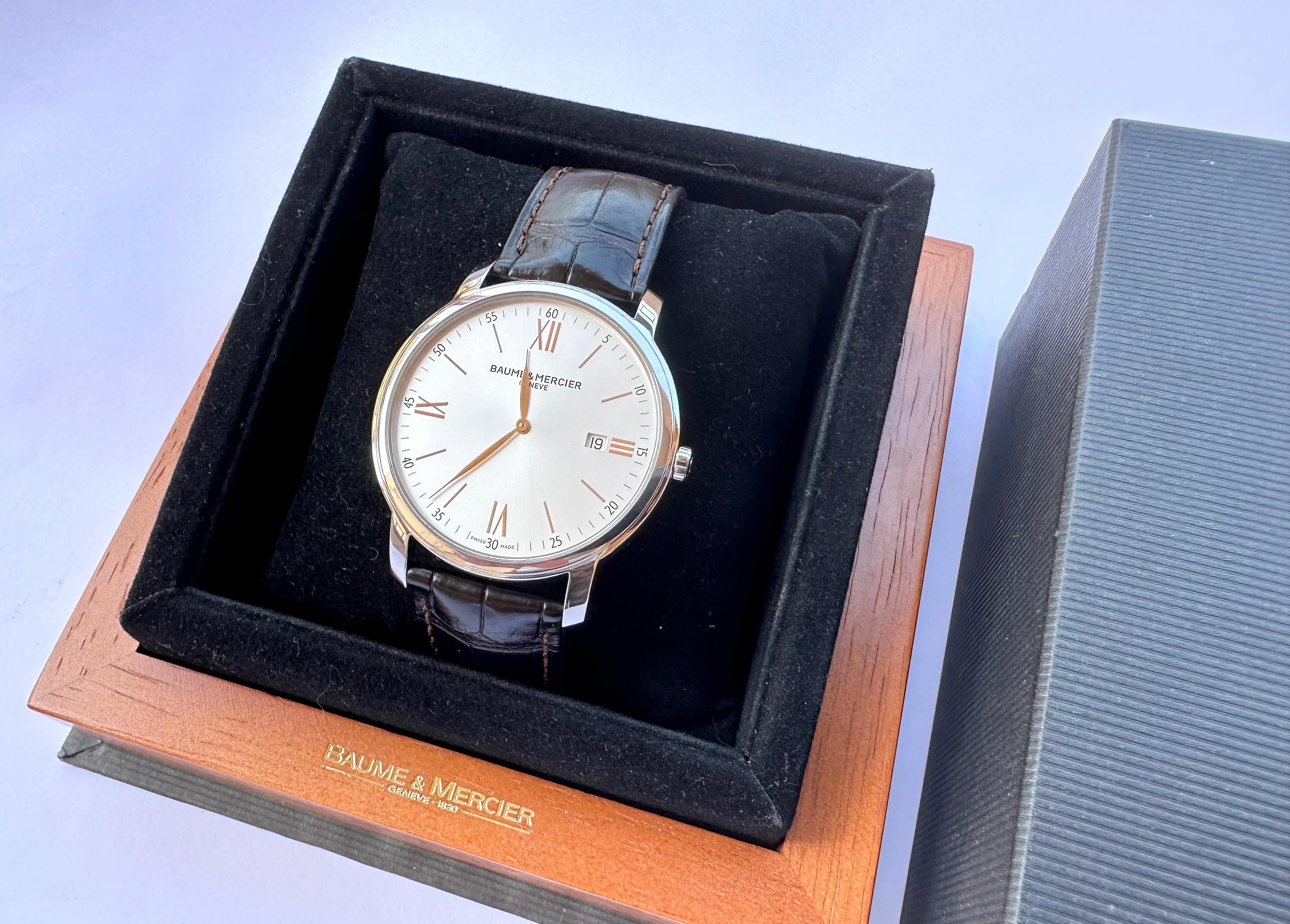 Brand: Baume & Mercier

Model: Classima

Reference Number: 65493

Country Of Manufacture: Switzerland

Movement: Quartz

Case Material: Stainless steel

Measurements : Case width: 42 mm (without crown)

Band Type : Baume & Mercier Leather

Band