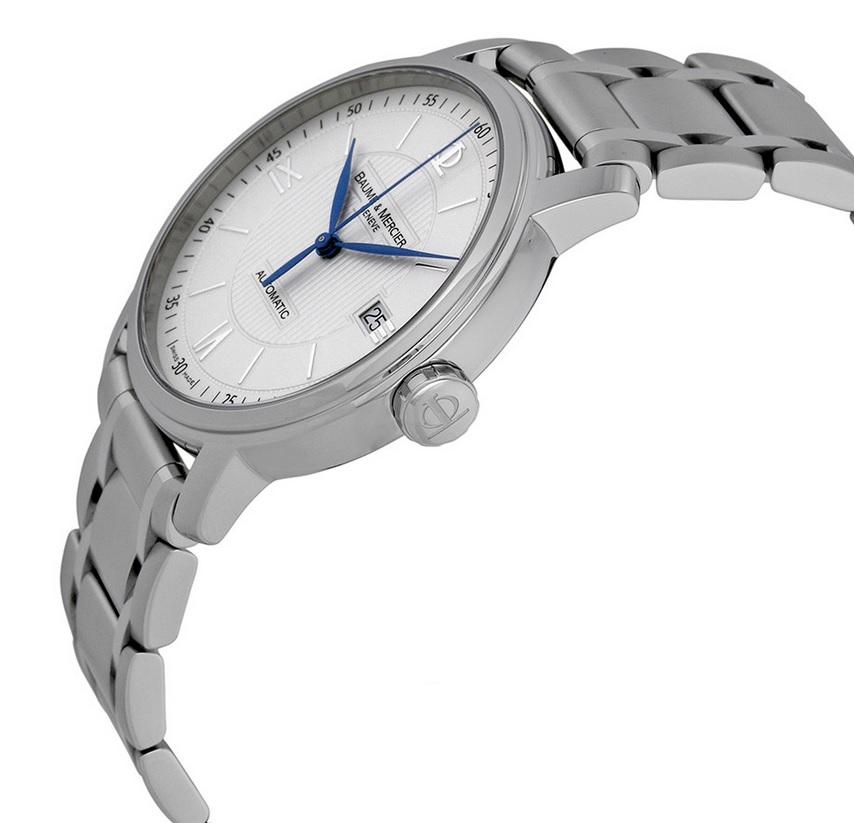 Stainless steel case with a stainless steel bracelet. Fixed stainless steel bezel. Opaline silvered, line gilloche decor dial with blue-steel hands and index hour markers. Roman numerals mark the 3, 6, 9 and 12 o'clock positions. Minute markers