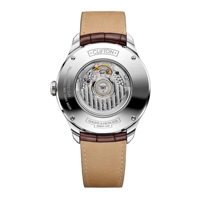 Stainless steel case with a brown leather strap. Fixed stainless steel bezel. Silver dial with gold-tone hands and alternating Arabic numeral and index hour markers. Minute markers around the outer rim. Dial Type: Analog. Three displays showing: day