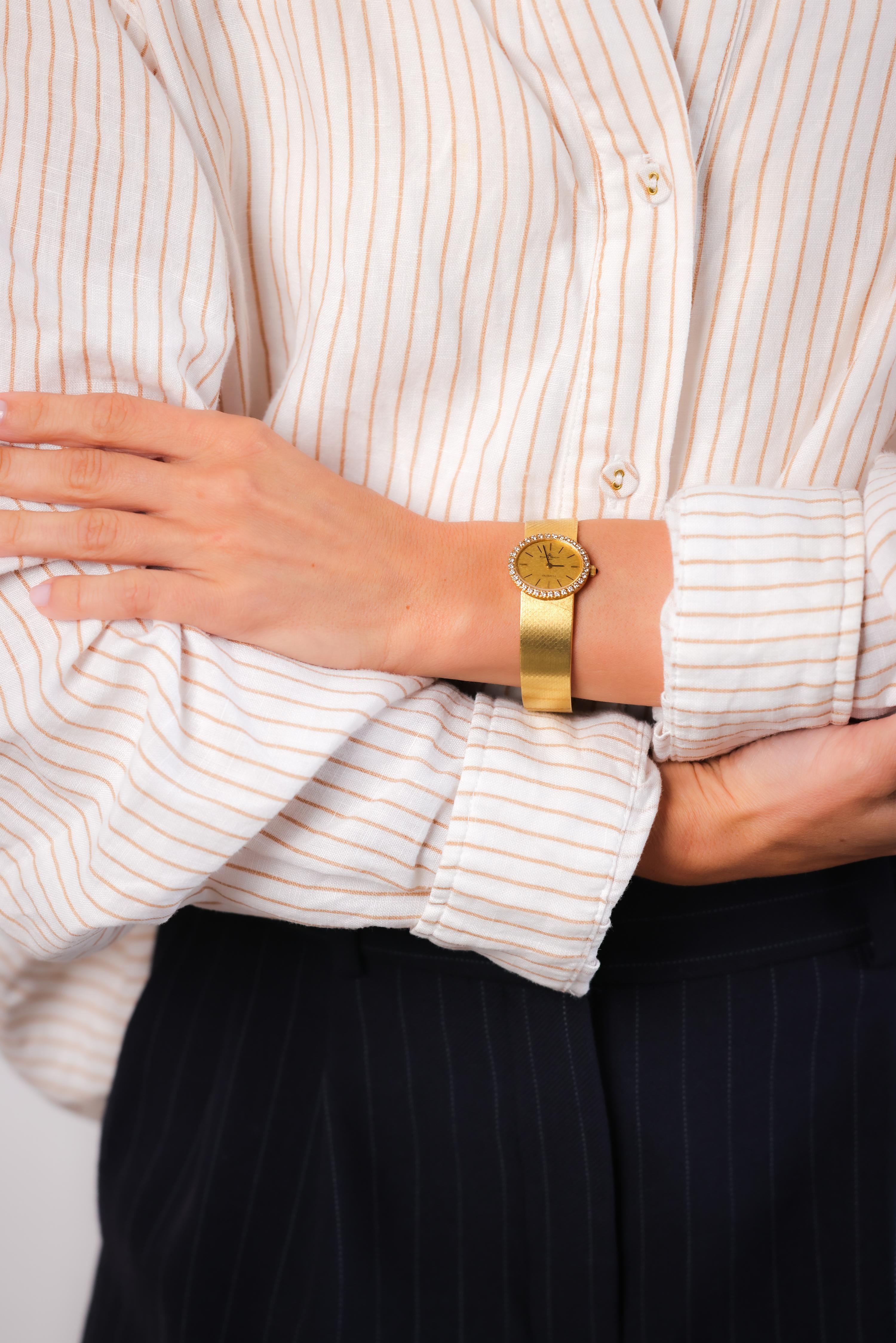 Brand: Baume & Mercier
Movement: Quartz
Center Stone: 32 Round Brilliant Cut Diamonds
Weight: Approximately .80 Carats
Color: F
Clarity: VS
Metal: 18K Yellow Gold 
Era: Vintage
Circa: 1980's 
Hallmarks: Signed, Numbered, Made in Swiss, Purity, and