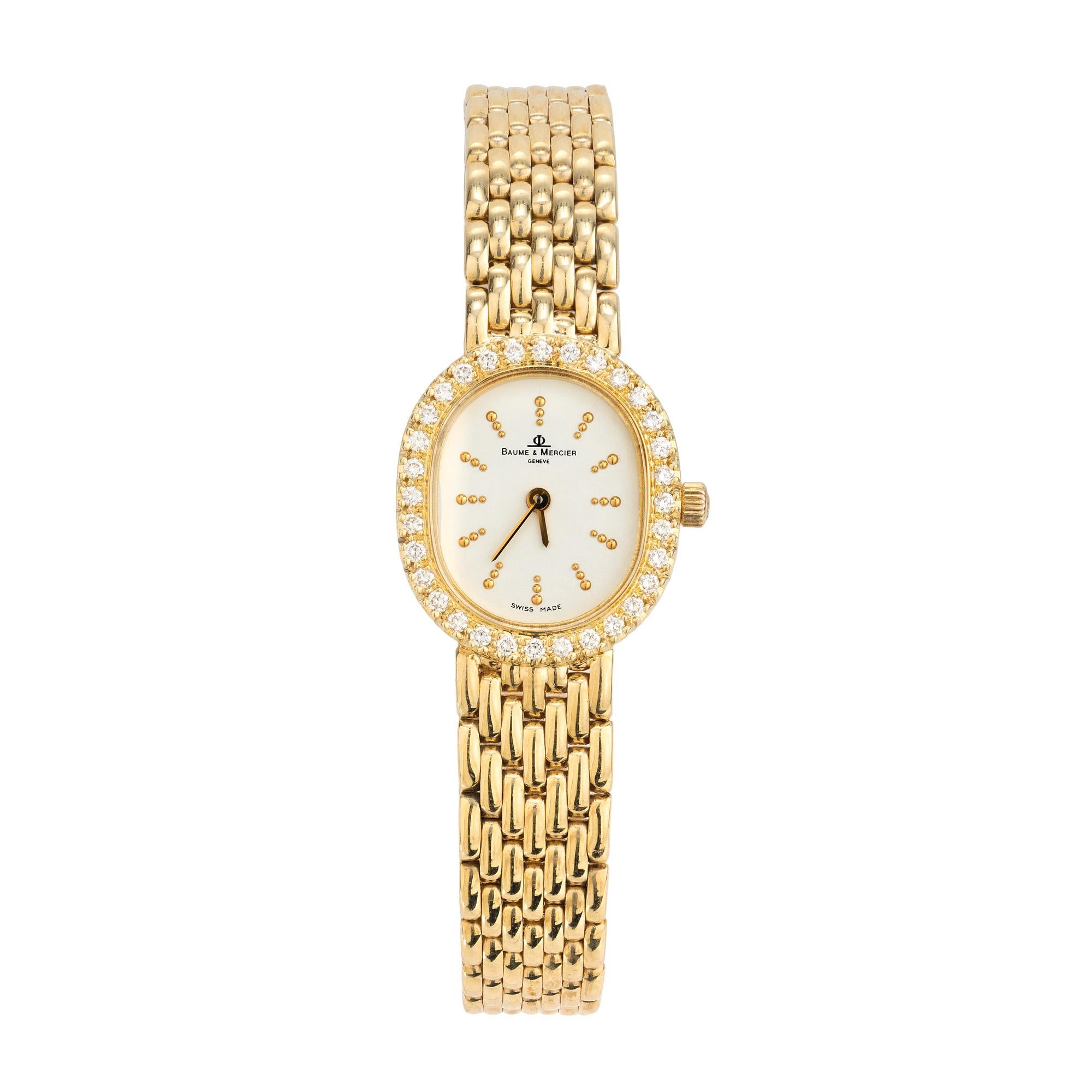 Experience the epitome of elegance with the Baume 
Mercier Diamond Bezel Yellow Gold Ladies Wristwatch. Quartz movement. The oval shape case is glistening with a halo of round cut diamonds. The 7 inch panther style bracelet is 14k yellow gold.