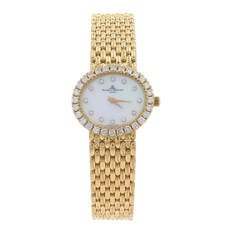 Brand: Baume & Mercier 
Model Number: 18310 9 
Dial Color: Mother of Pearl & Diamonds 
Year Range: 2000 - 20009 
Metal Content: 18k Yellow Gold 
Movement: Quartz 
Warranty: One-Year

Stone Information (bezel): 
Natural Diamonds 
Total Carats: