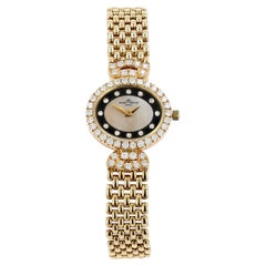 Baume & Mercier: Gold, Diamond, and Mother of Pearl Watch on Gold Bracelet