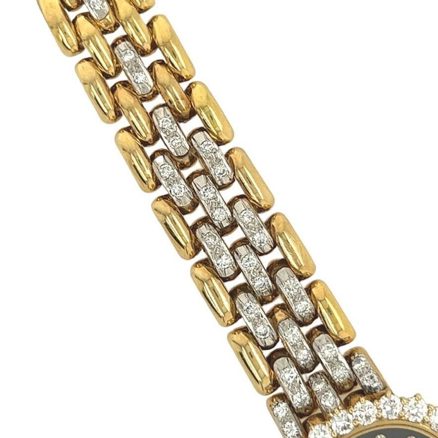 Eine Uhr aus 18 Karat Gelb- und Weißgold, Emaille und Diamanten, Baume & Mercier.  Das Quarzwerk Uhr als horizontale oval das Zifferblatt aus schwarzem Email mit Diamanten Indexe innerhalb einer Gelbgold Lünette mit zweiundzwanzig (22) runde