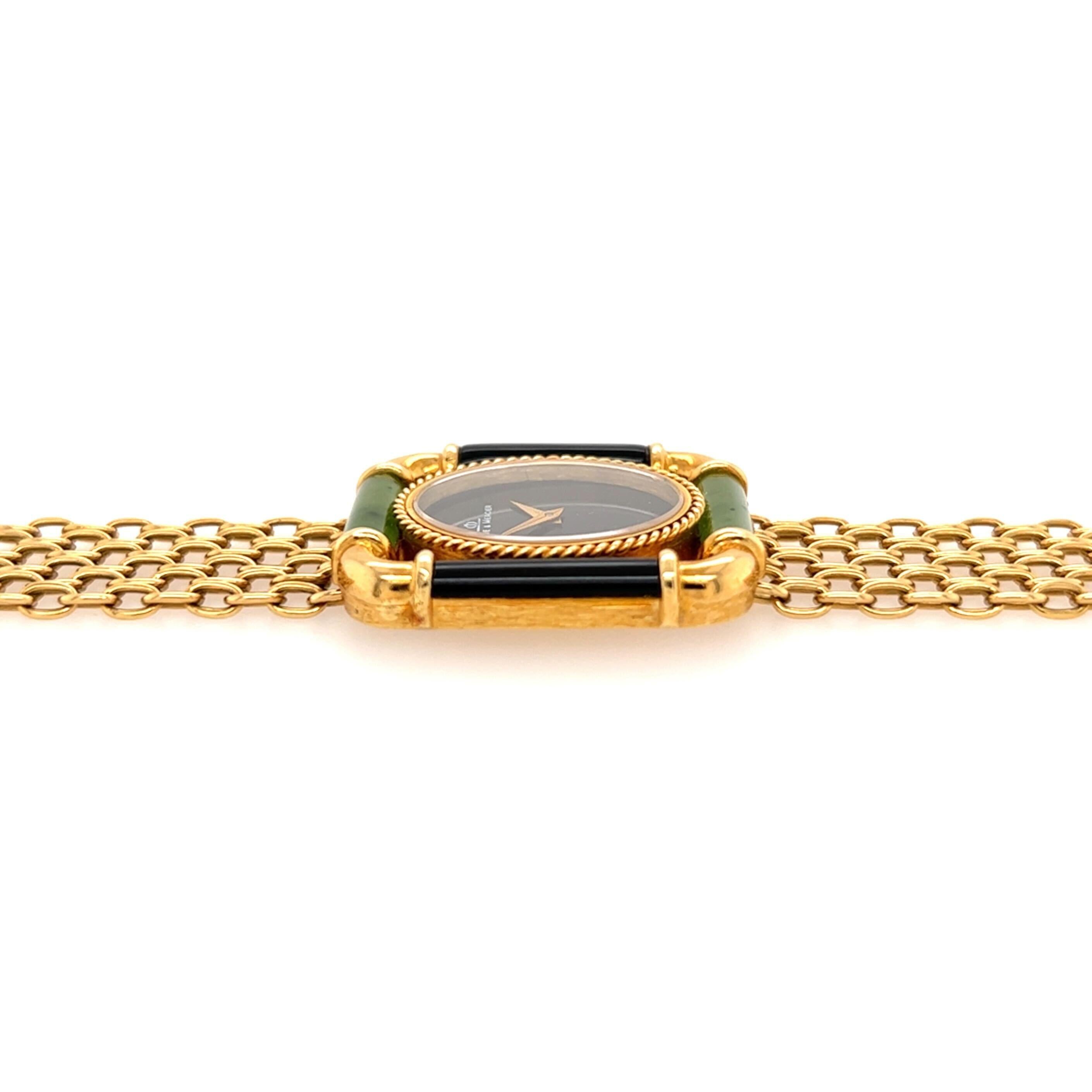 An 18 karat yellow gold, nephrite and black onyx watch, Baume & Mercier.  The black oval dial within a ropework case enclosed in an open rectangular frame with bars of nephrite at the top and bottom, and bars of black onyx on each side, completed by